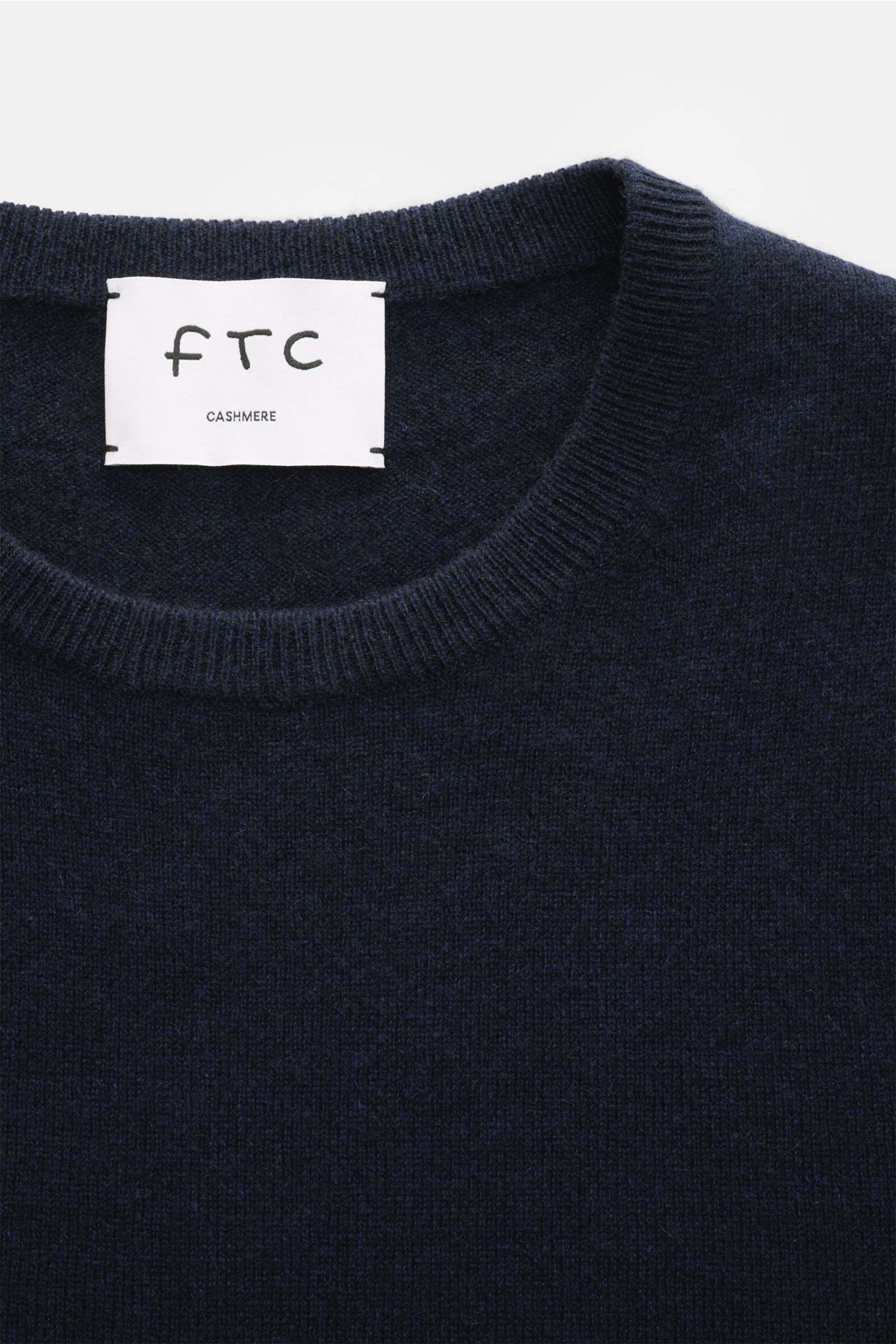 Close-up front view of FTC Cashmere crew neck jumper navy, showing fine knit texture and ribbed crew neck collar made of pure, ultra soft cashmere.

The feel of ultra soft cashmere fabric makes this timeless crew neck jumper by sustainable knitwear lab