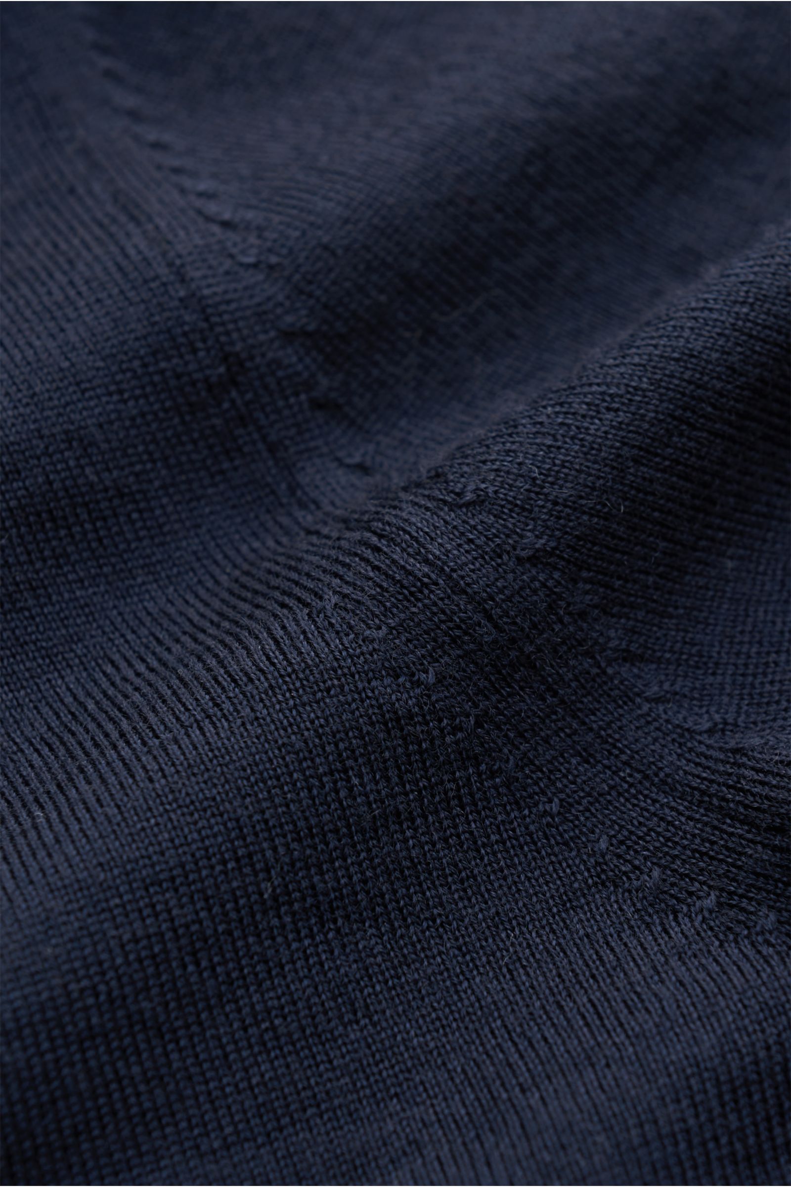 Nahaufnahme des von Braun Merino Rundhalspullover navy aus reiner Merinowolle mit feinem Strickbild, weichem Griff und elastischen Rippbündchen.