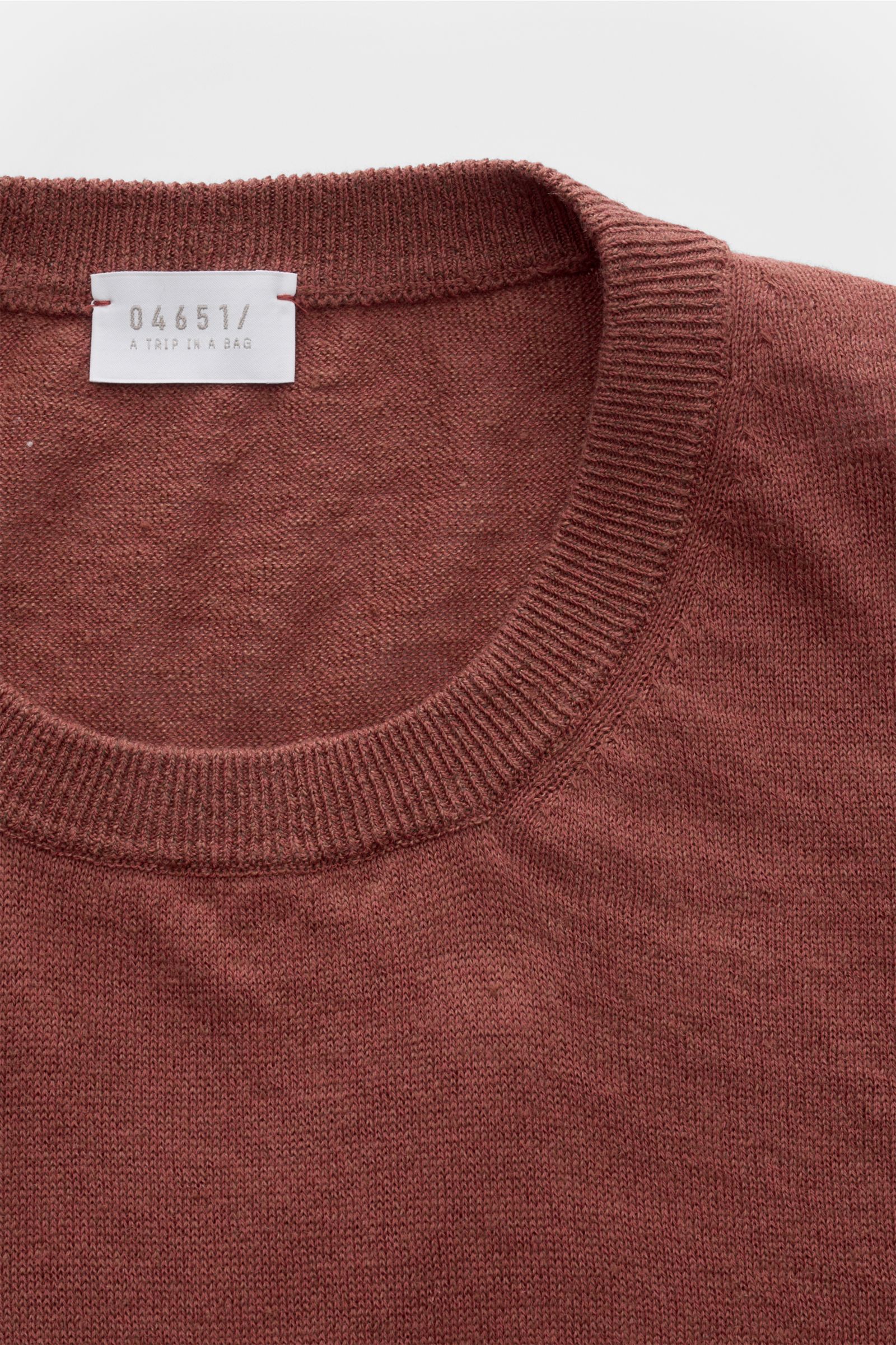 04651/ A trip in a bag Feinstrick-Kurzarmpullover 'Pocket Tee' rostbraun, Nahaufnahme von Rundhalsausschnitt und feinem Strick aus Leinen-Baumwolle.