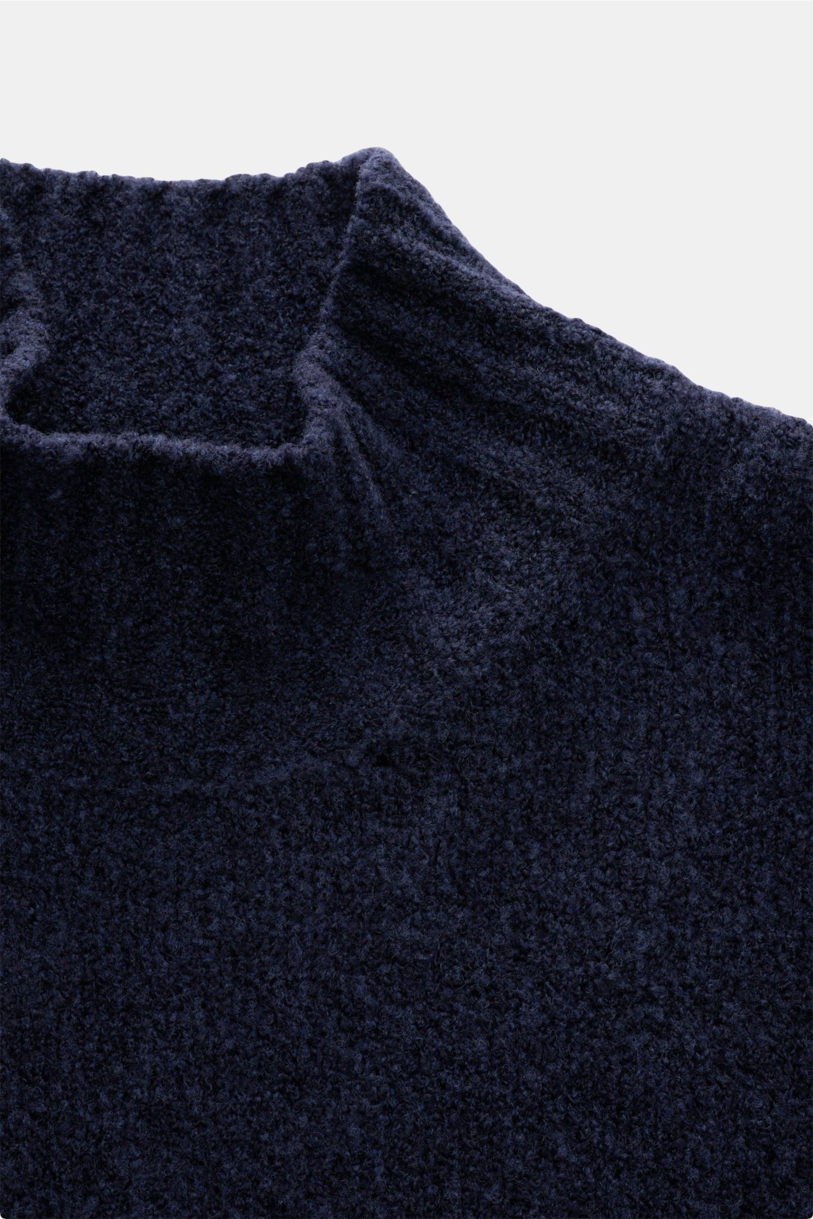 Close-up front view of the 04651/ A trip in a bag Mock neck jumper 'Grainy' navy melange showcasing its warm wool blend bouclé knit texture and high rib knit collar.

For modern looks: The jumper 'Grainy' by 04651/ A TRIP IN A BAG is made of a warm woo
