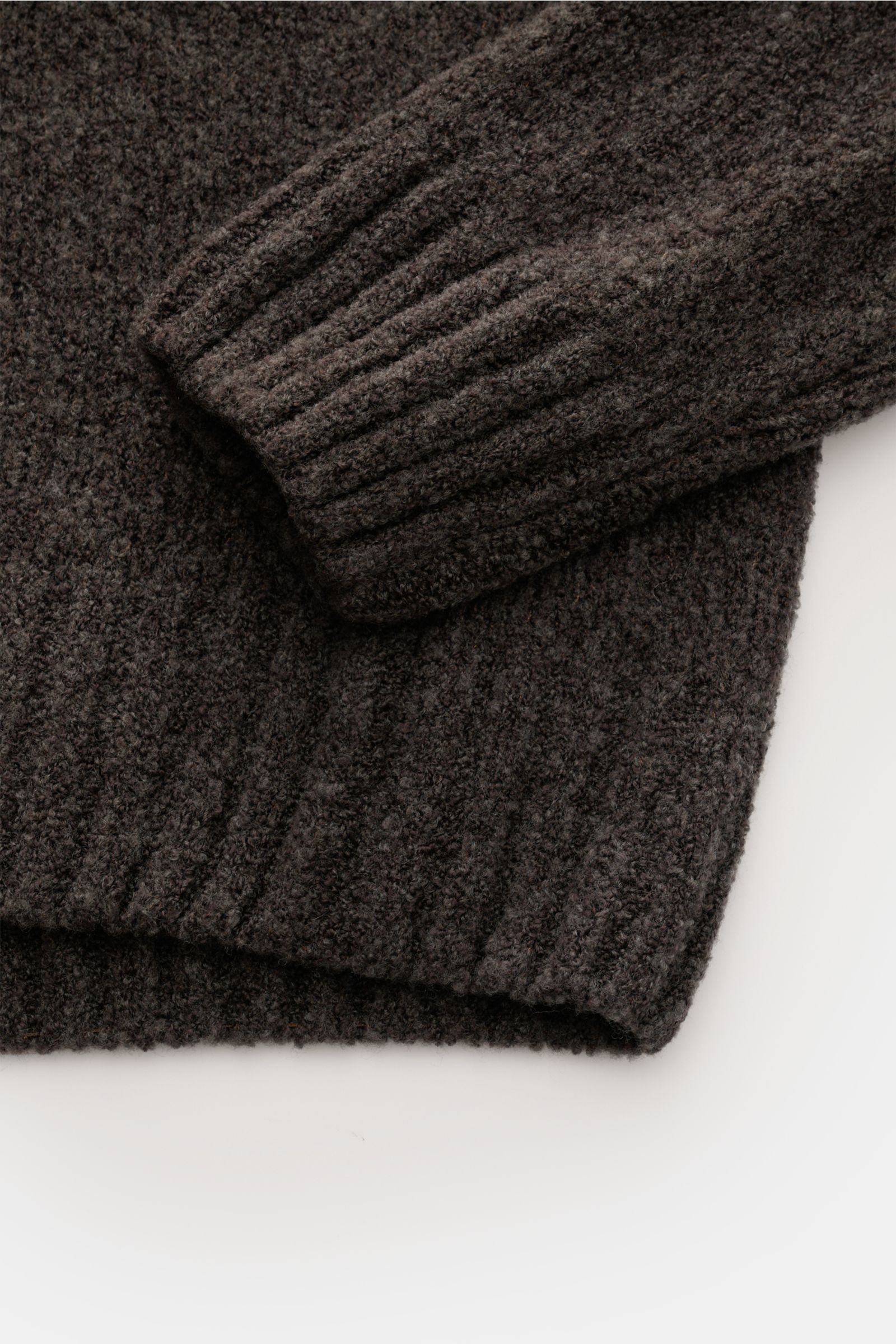 04651/ A trip in a bag Mock Neck Pullover 'Grainy' graubraun, Detailfoto von Ärmel und Saum aus wärmendem Woll-Mix Boucléstrick.