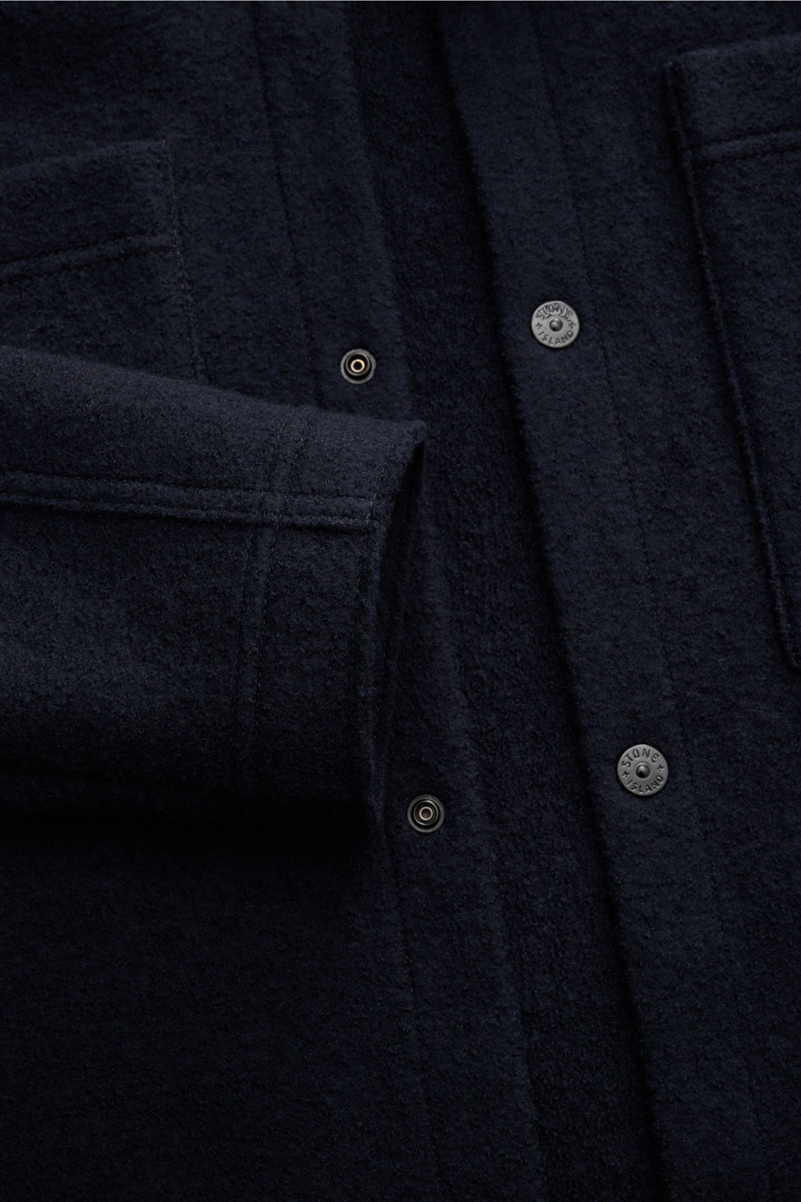 Close-up front view of Stone Island Overshirt navy made of reine, gefilzte Wolle, soft touch, garment dyed, Regular Fit, Druckknopfleiste, Umlegekragen, aufgesetzte Brusttaschen, and typical Kompass-Badge on sleeve.