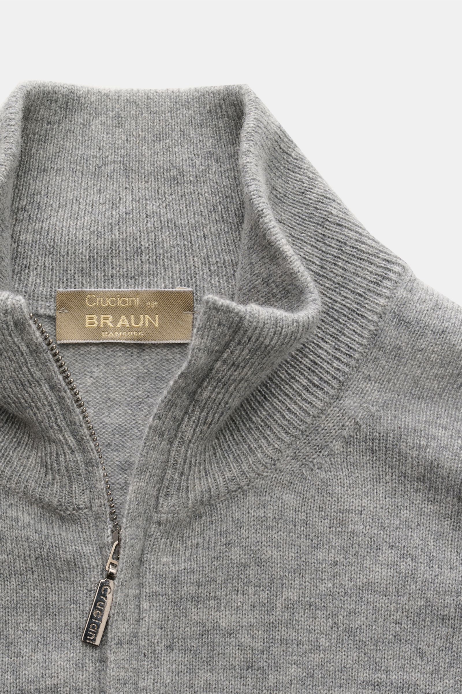Close-up front view of Cruciani Cashmere Troyer grau meliert, a grey melange slim-fit cashmere sweater with a ribbed Troyer collar and zipper.

Durch die Verwendung feinster, geschmeidiger Cashmere-Garne entsteht bei CRUCIANI ein klassisch leichter Tro