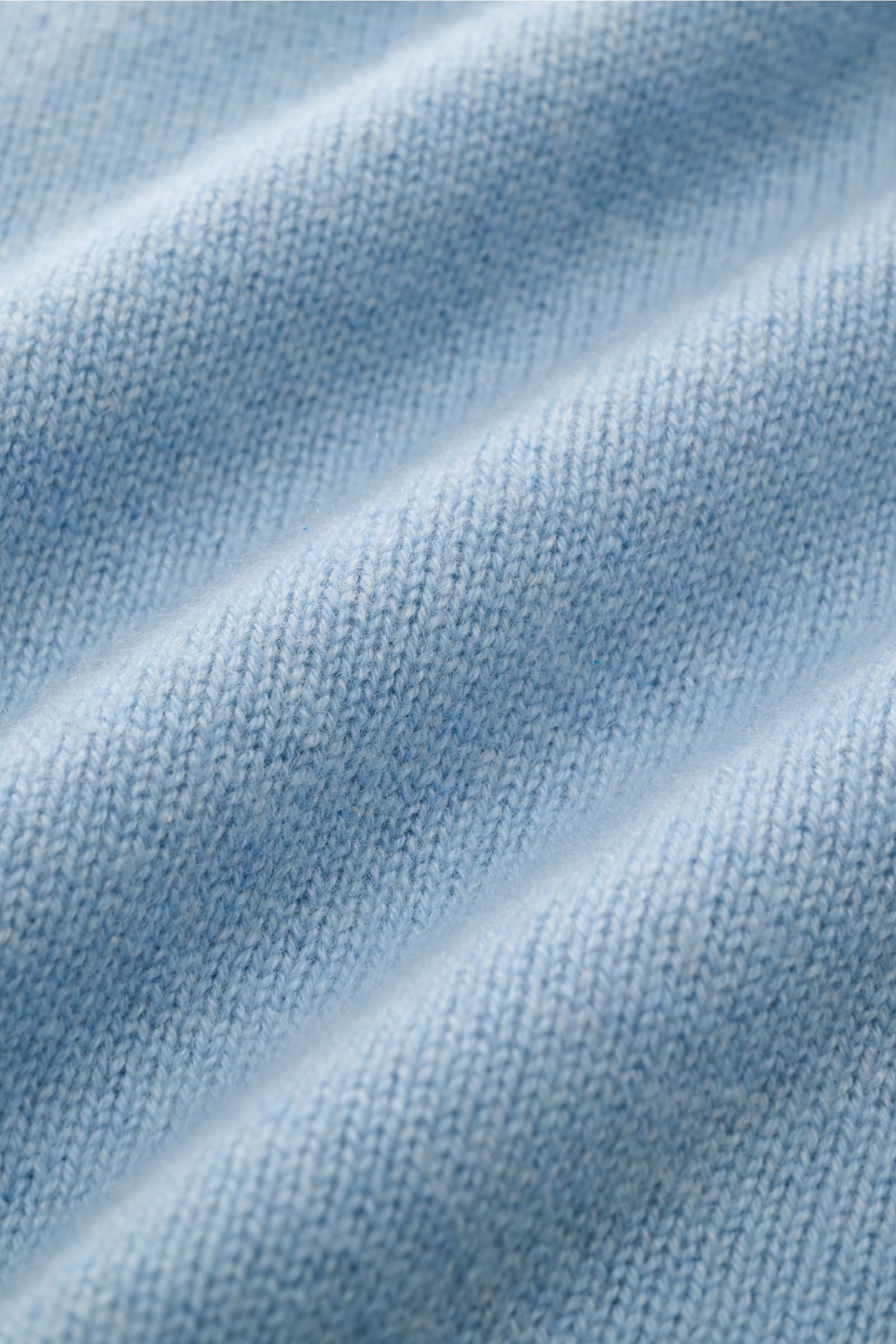 Close-up front view of the FTC Cashmere half-zip jumper light blue showing fine knit texture and soft fabric detail.

Description: Stay cosy and warm in the colder months with this timeless half-zip jumper by FTC made of high-quality Fair Trade cashmer