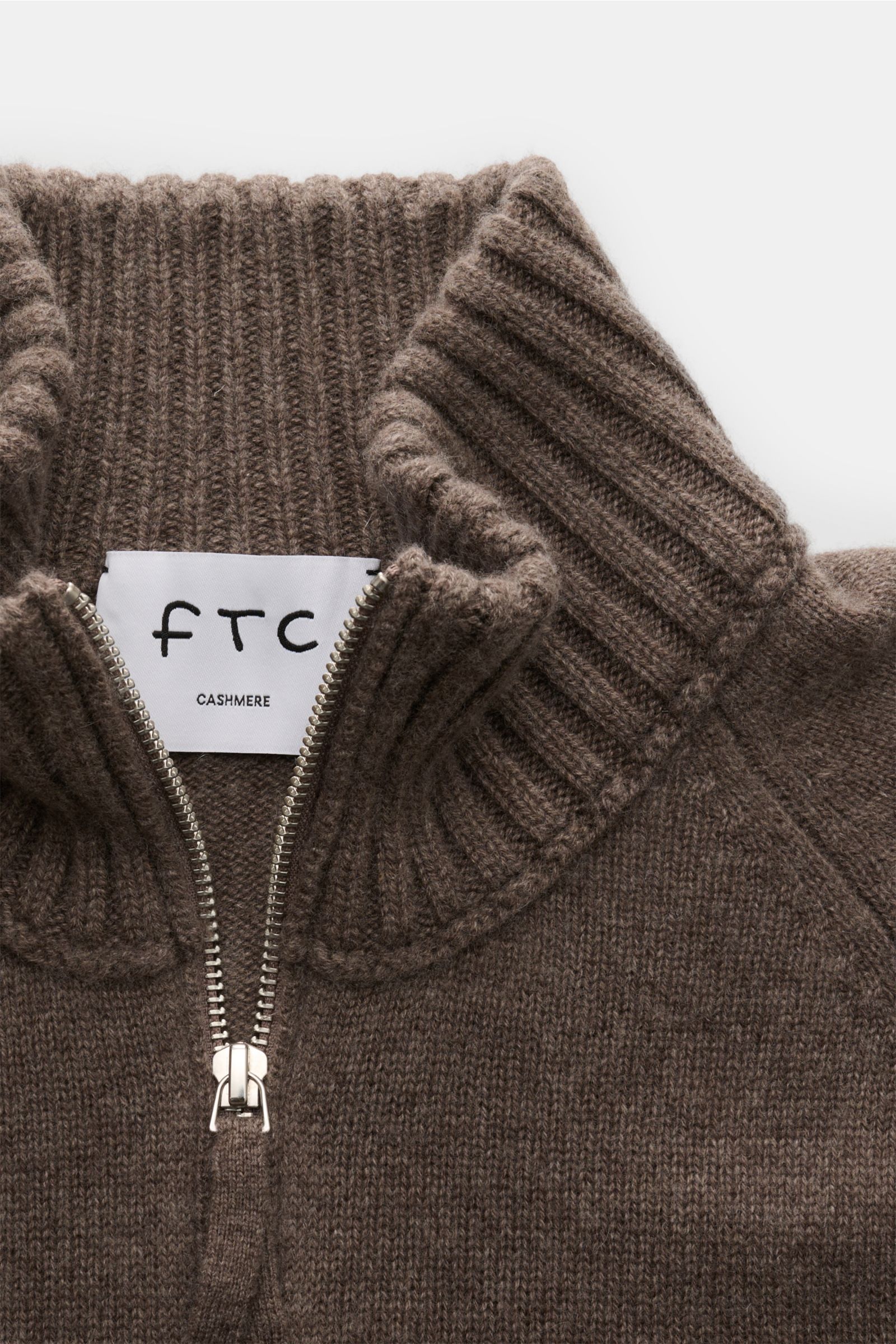 Close-up front view of the FTC Cashmere half-zip jumper grey-brown showing the ribbed half-zip collar and medium-fine knit texture. Stay cosy and warm in the colder months with this timeless half-zip jumper by FTC made of high-quality Fair Trade cashme