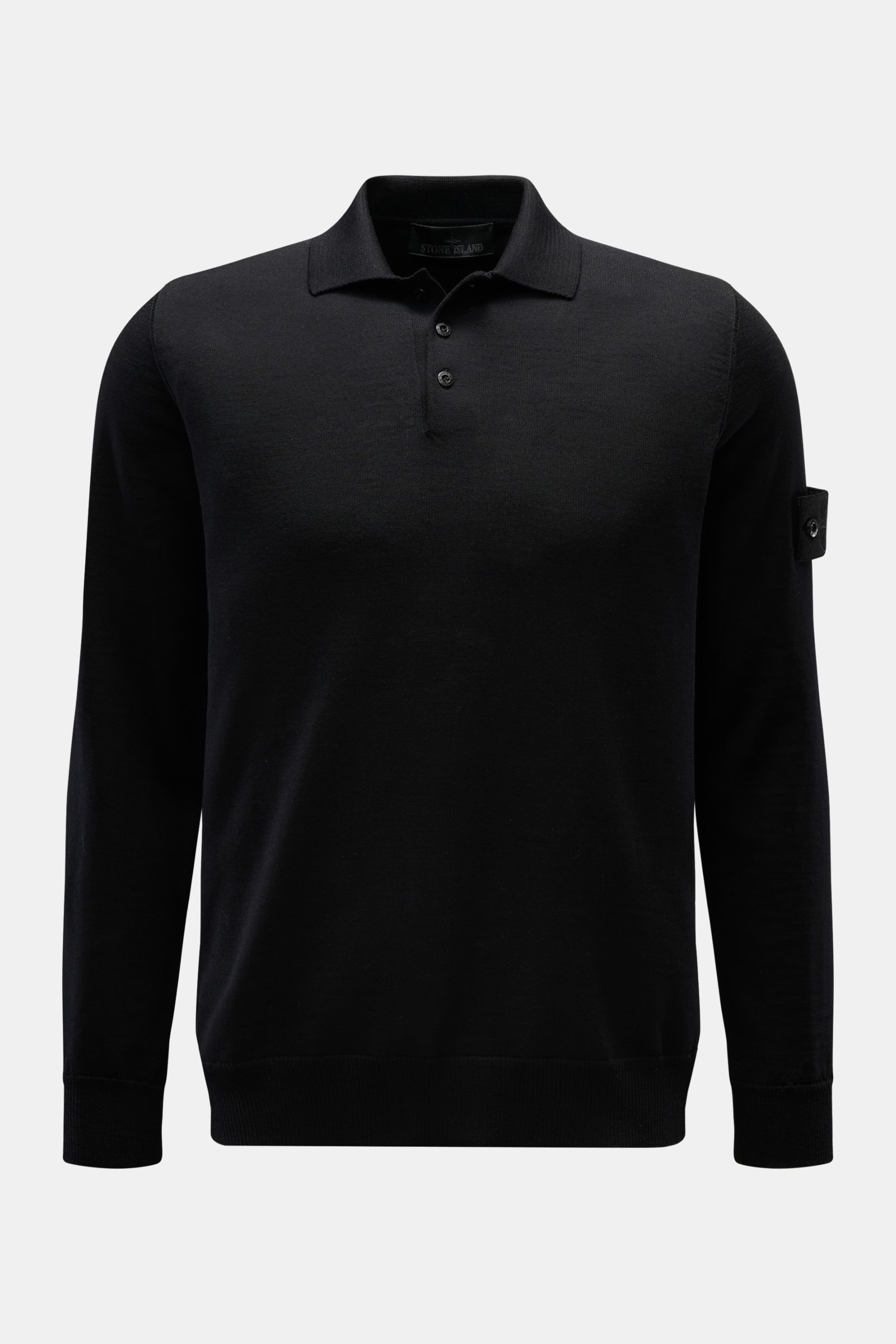 Stone Island Strickpolo 'Ghost Pure Light Wool' schwarz, frontal fotografiert, feiner Strick, Regular Fit, Umlegekragen, Kompass-Badge am Oberarm, Rippbündchen, weicher Griff, vielseitiger Klassiker.