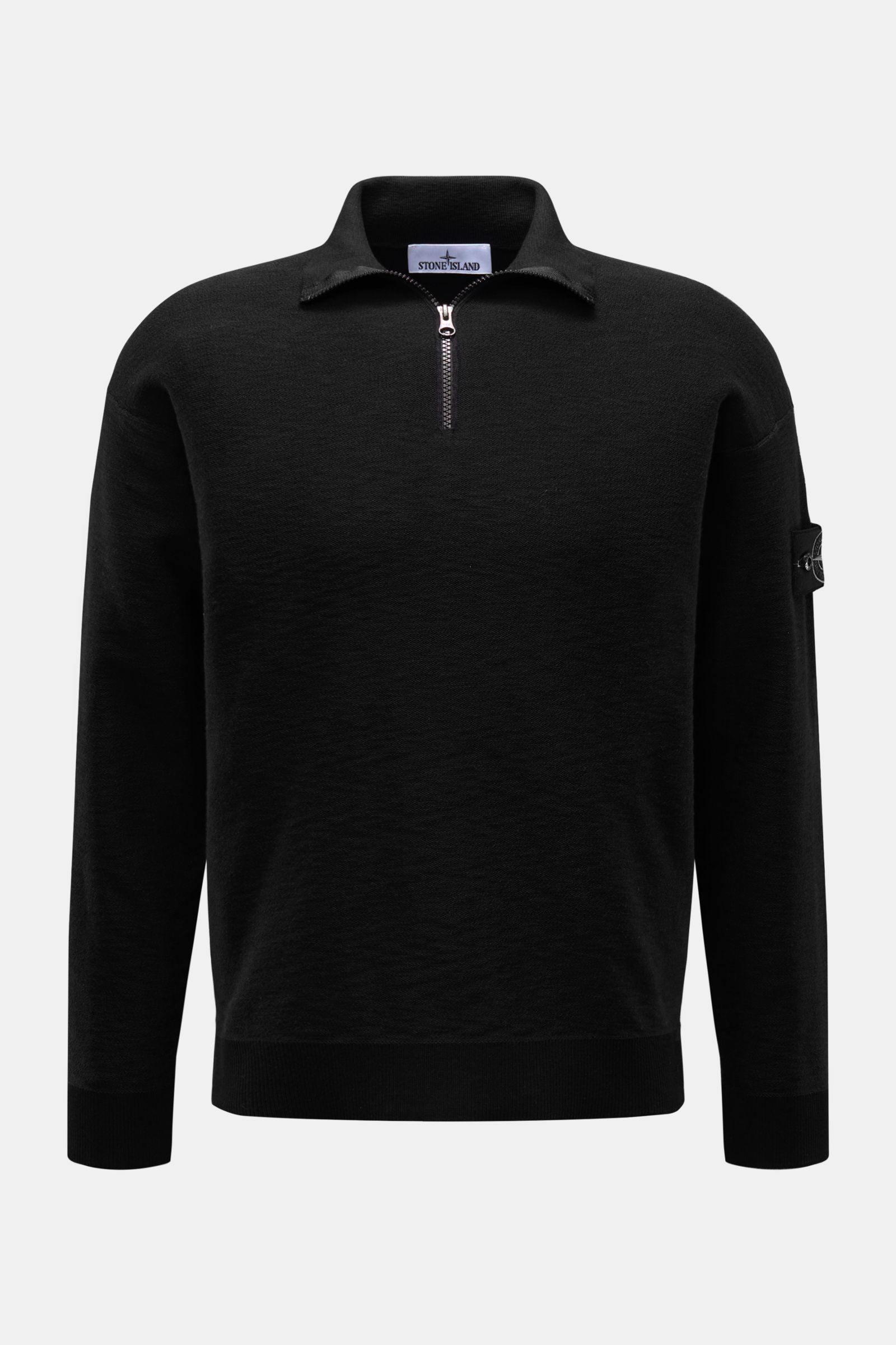 Stone Island Half-zip jumper black shown from the front, featuring a slim fit, standing collar with zipper, purl stitch texture, and signature compass badge. Knit with a twist: The sporty half-zip jumper by STONE ISLAND in a modern purl stitch is an ideal
