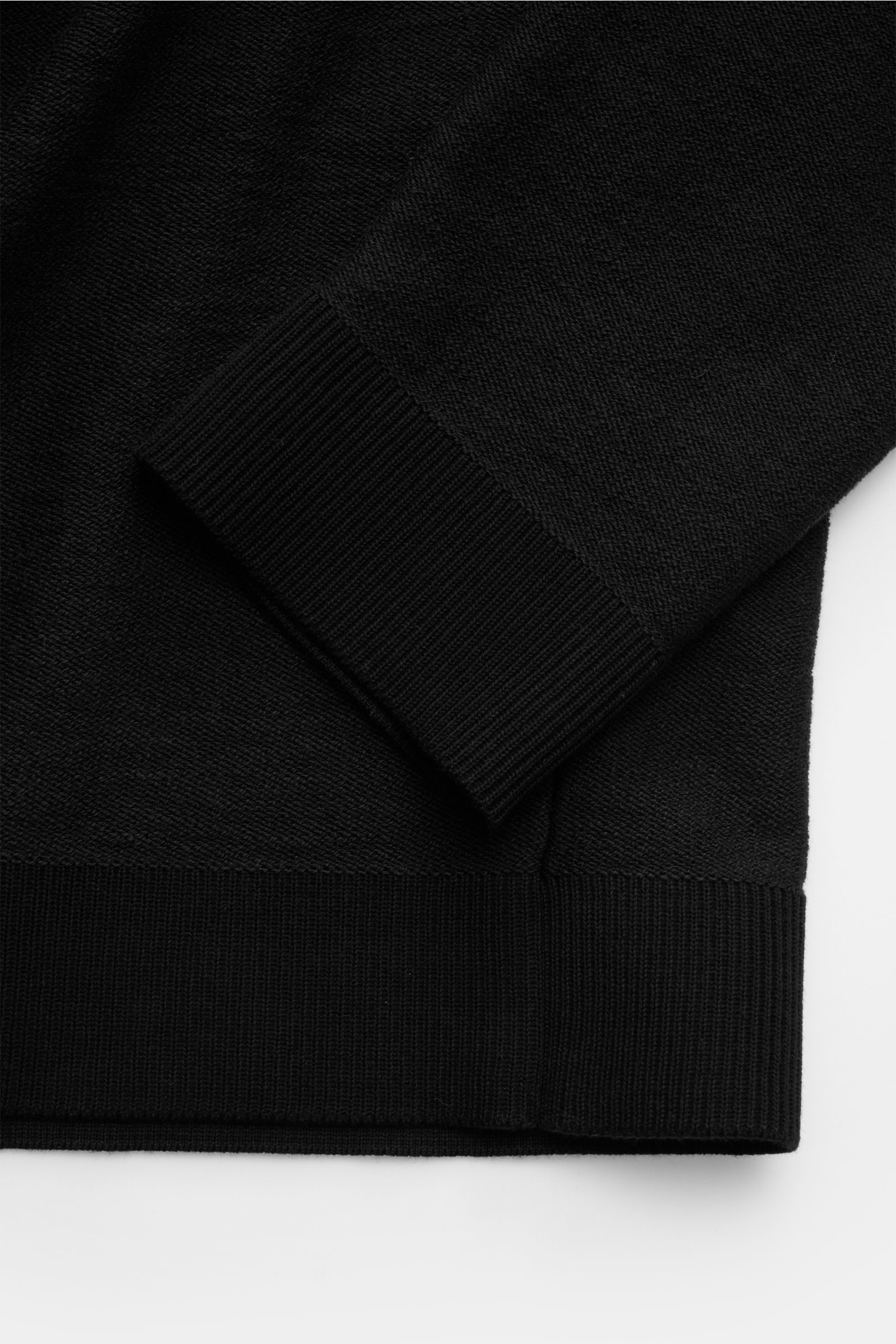 Close-up view of the Stone Island Half-zip jumper black showing the rib knit bands and purl stitch texture on the sleeve and hem.