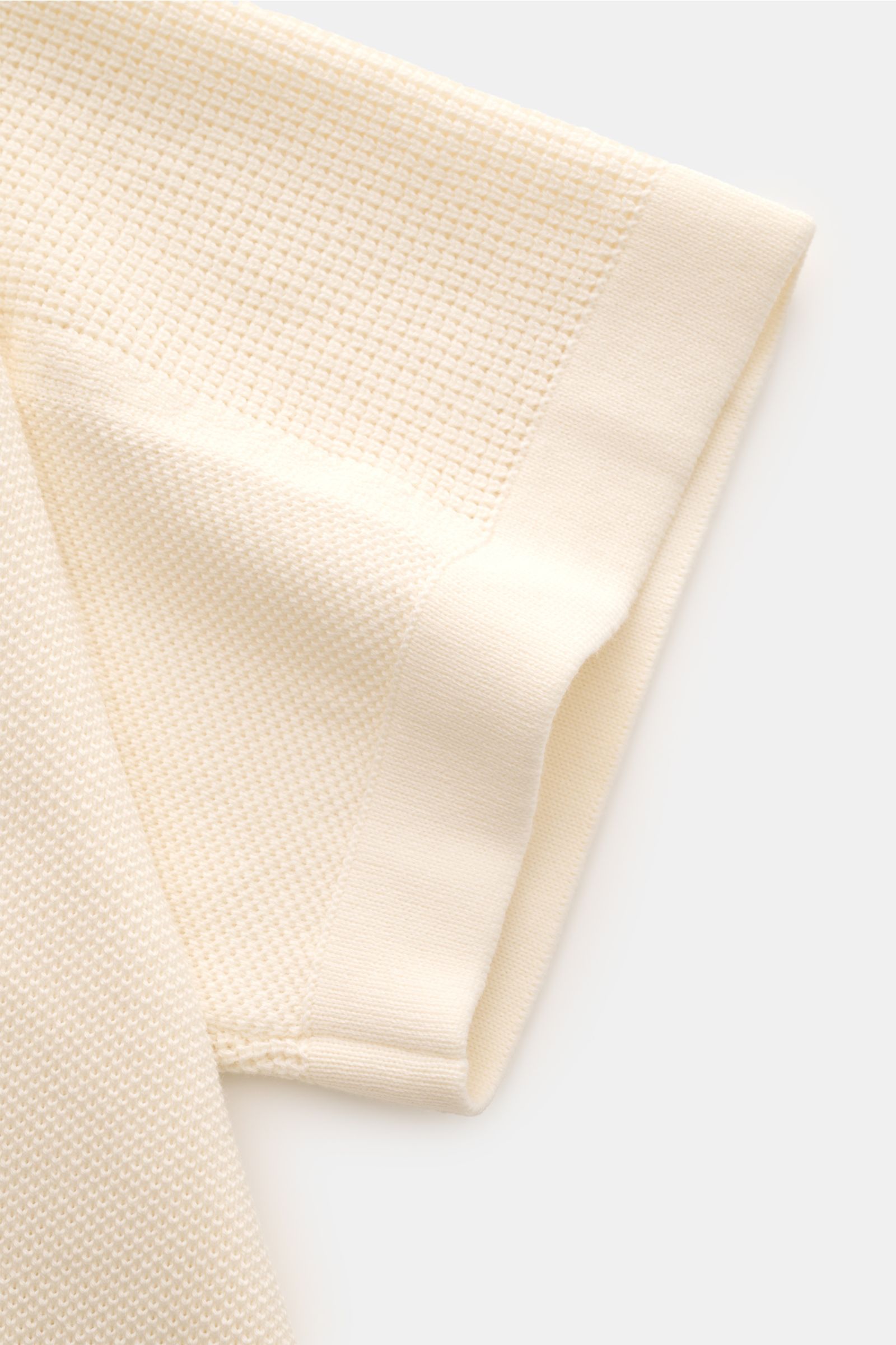 Stone Island Kurzarm-Strickpolo creme, Detailansicht des Ärmels aus reiner Baumwolle mit feinem Piqué-Mix, Polokragen und Weblabel.