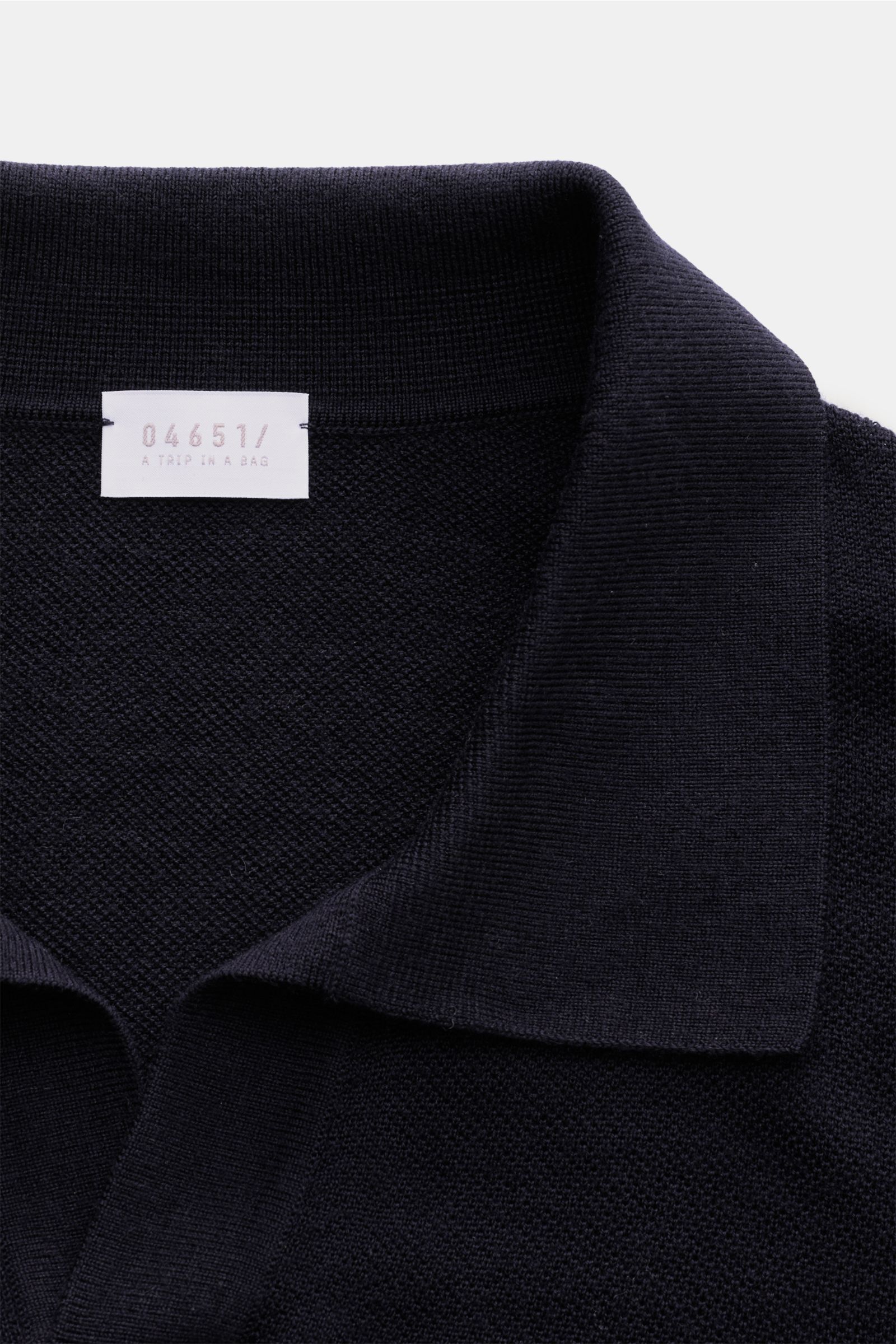 Close-up front view of 04651/ A trip in a bag Knit polo 'Johnny' navy showing fine knit texture and narrow collar.

Stylish comfort: This knit polo by 04651/ A TRIP IN A BAG in comfortable pure wool material is a versatile favourite for the autumn and 