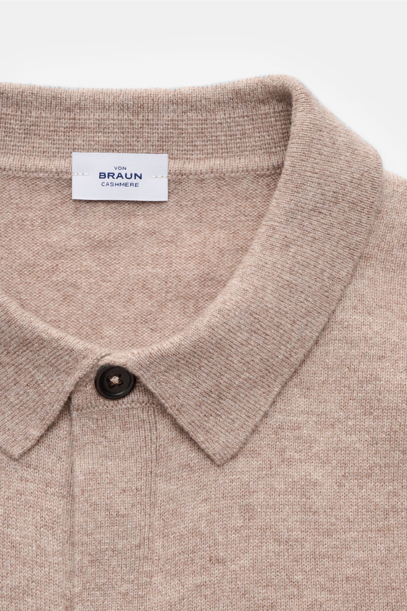 Close-up front view of the von Braun Cashmere knit shirt beige showing the fine knit, slim fit collar, and smooth button placket.

Luxurious winter essential: This VON BRAUN knit shirt in the finest Mongolian cashmere has a timeless design that offers 