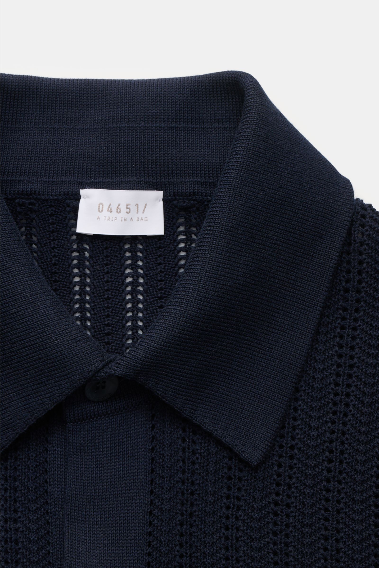 Close-up front view of the 04651/ A trip in a bag Short sleeve knit shirt narrow collar navy, showing textured knit and narrow collar.

Summery ease: With a casual cut and comfortable cotton, this short sleeve knit shirt by 04651/ A TRIP IN A BAG is th