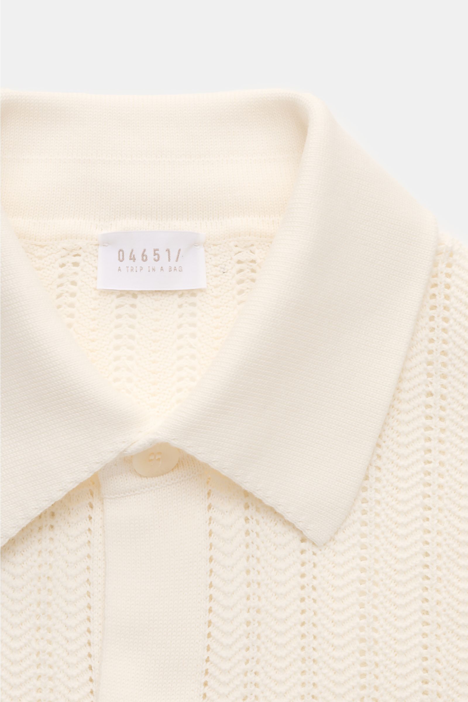 Close-up front view of 04651/ A trip in a bag Short-sleeved knit shirt narrow collar cream with textured pure cotton knit.

Summery ease: With a casual cut and comfortable cotton, this short sleeve knit shirt by 04651/ A TRIP IN A BAG is the perfect co