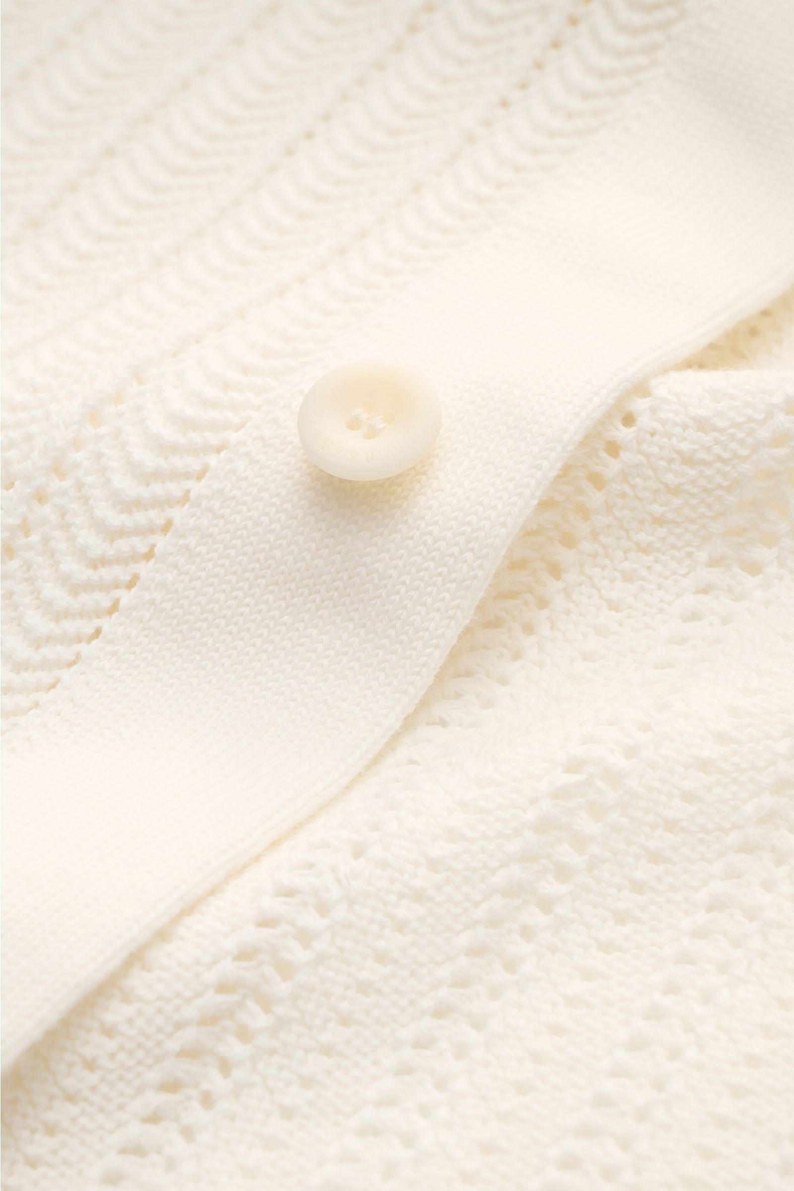 Close-up front view of the 04651/ A trip in a bag Short-sleeved knit shirt narrow collar cream showing textured knit, button, and ribbed bands.

Summery ease: With a casual cut and comfortable cotton, this short sleeve knit shirt by 04651/ A TRIP IN A 