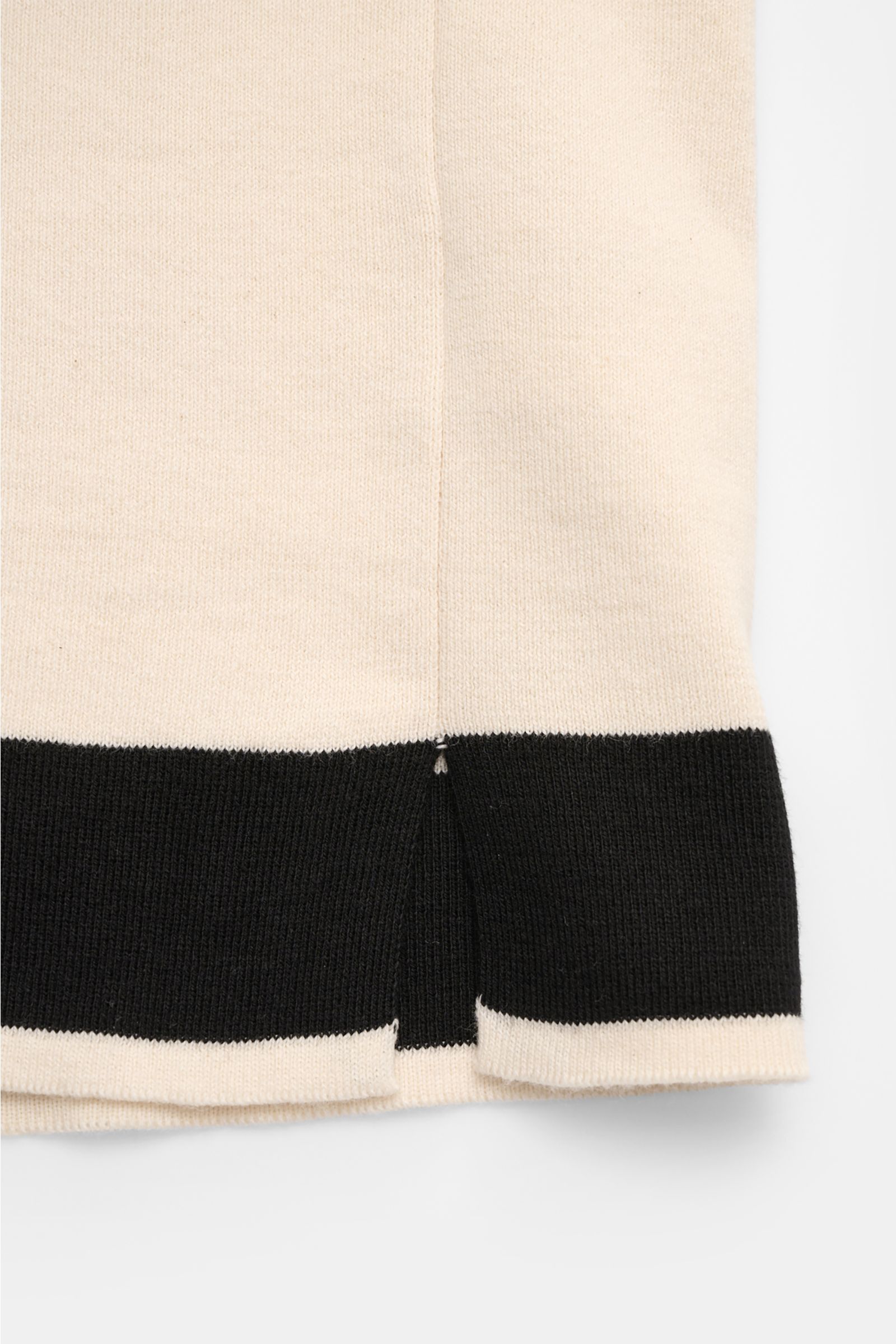 Close-up front view of 04651/ A trip in a bag Short sleeve knit shirt 'Colour Block' cream/black showing fine knit texture and colour block design. An eye-catching piece for summer: This short sleeve knit shirt by 04651/ A TRIP IN A BAG has a distinctive 