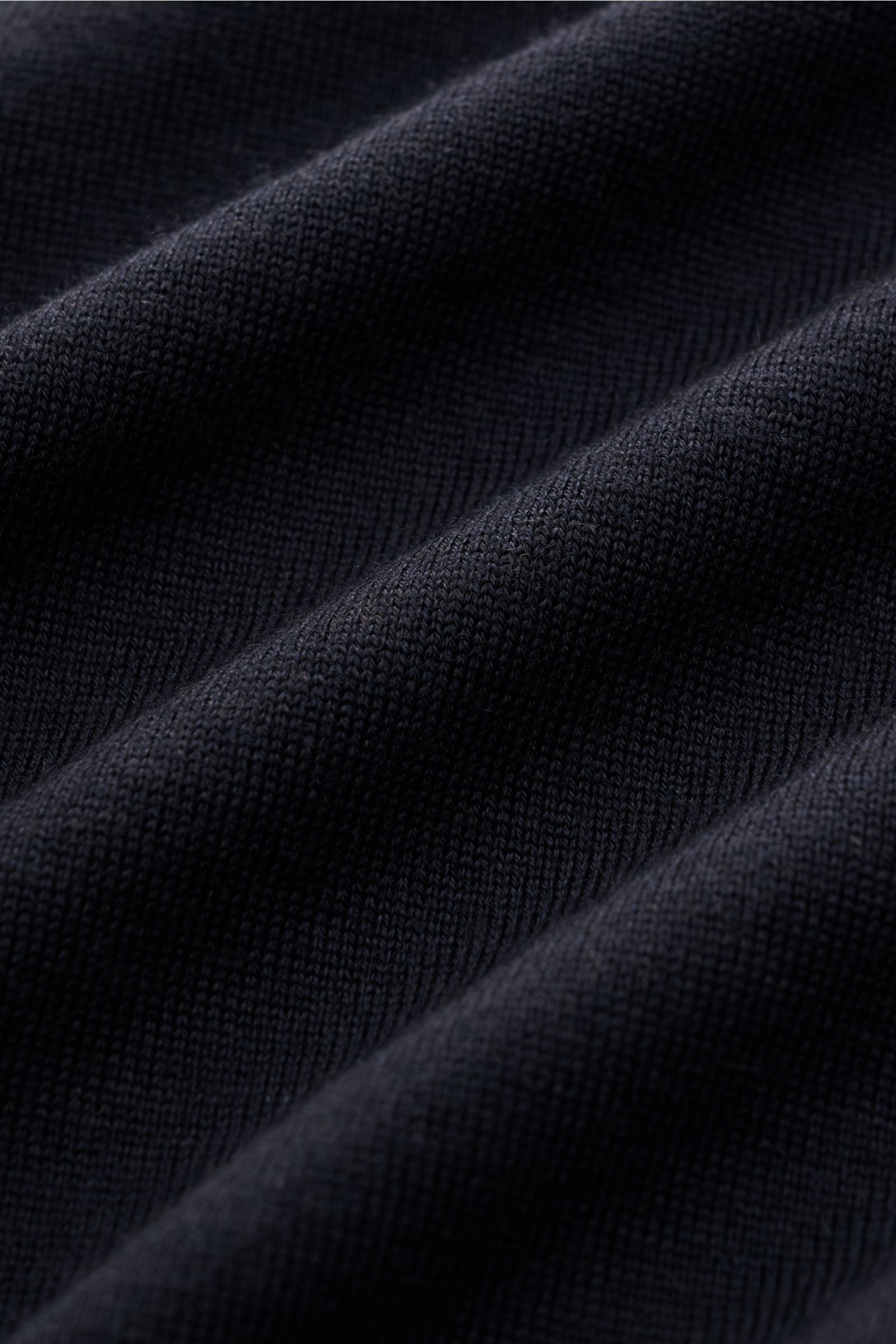 Close-up front view of Gran Sasso Fine knit polo navy fabric showing fine knit texture and soft folds, made from virgin wool, cashmere, and silk. Luxury you can feel on your skin: This long sleeve knit polo by BRAUN HAMBURG has an exceptionally soft feel 