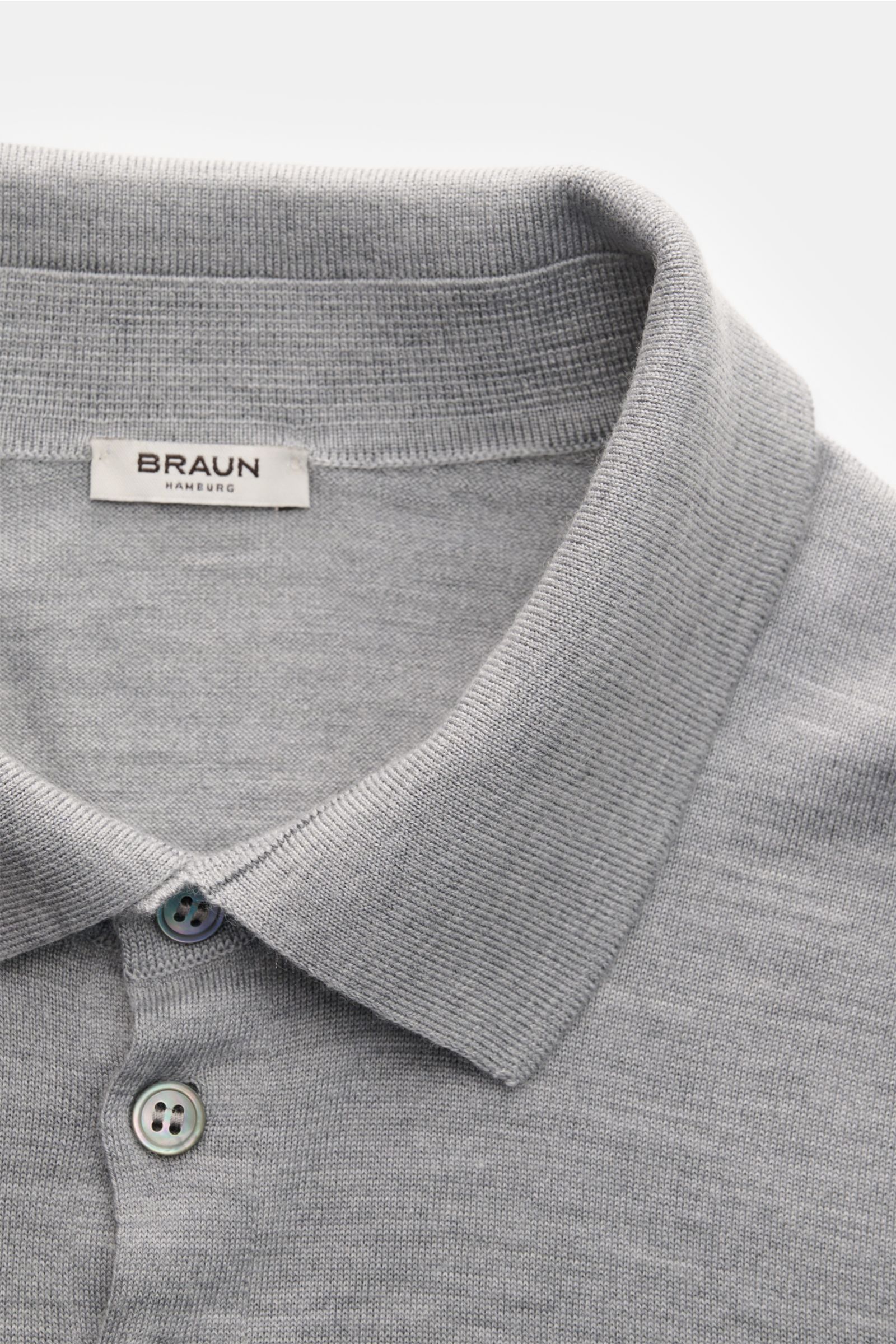 Gran Sasso Fine knit polo light grey mottled shown close-up from above, featuring a slim fit, soft virgin wool blend, ribbed collar, and four-button placket; luxury you can feel on your skin: This long sleeve knit polo by BRAUN HAMBURG has an exceptionall