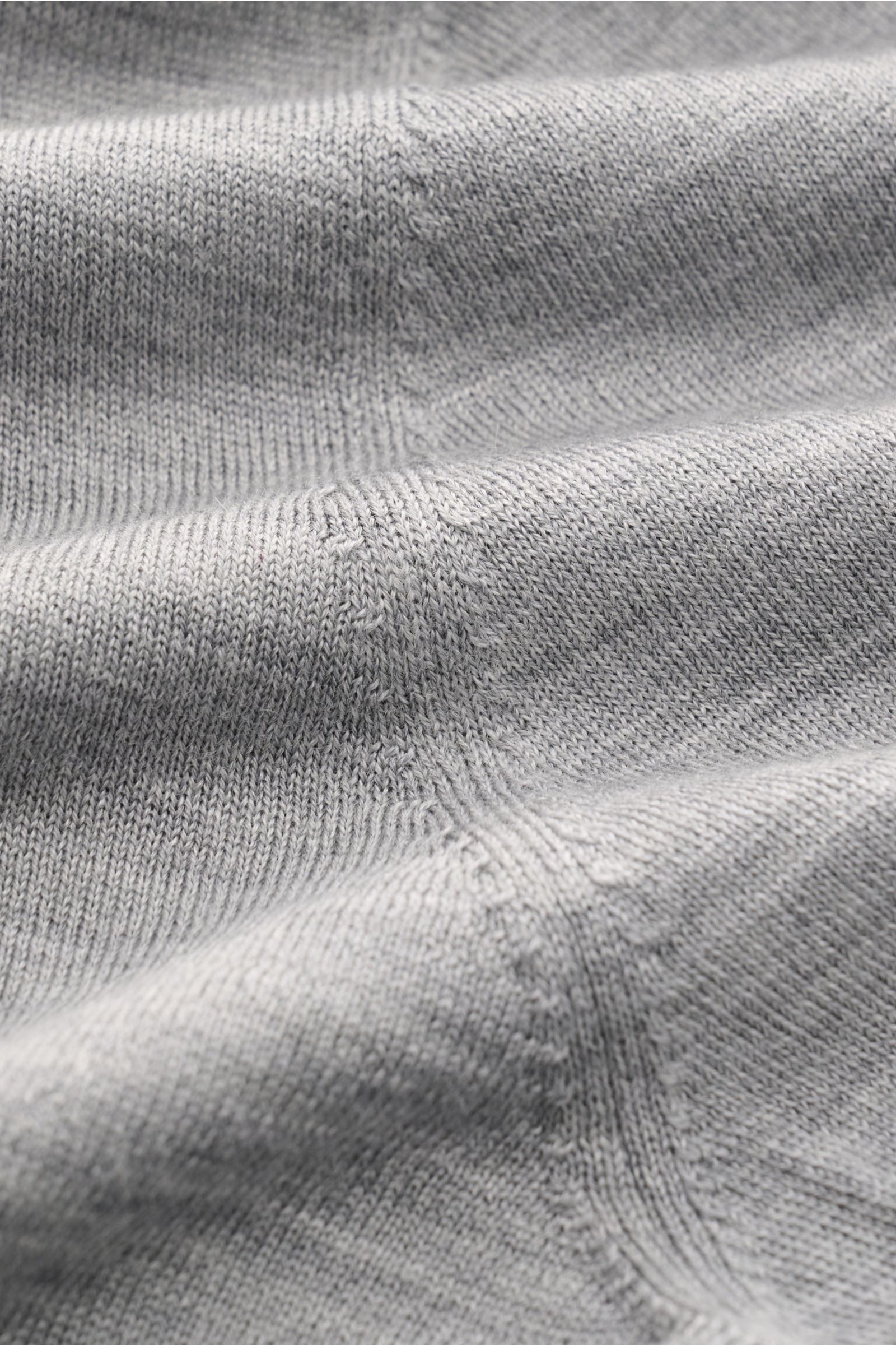 Gran Sasso Fine knit polo light grey mottled shown in a close-up from a top-down perspective, highlighting the very fine knit, soft texture, and seam details. Luxury you can feel on your skin: This long sleeve knit polo by BRAUN HAMBURG has an exceptional