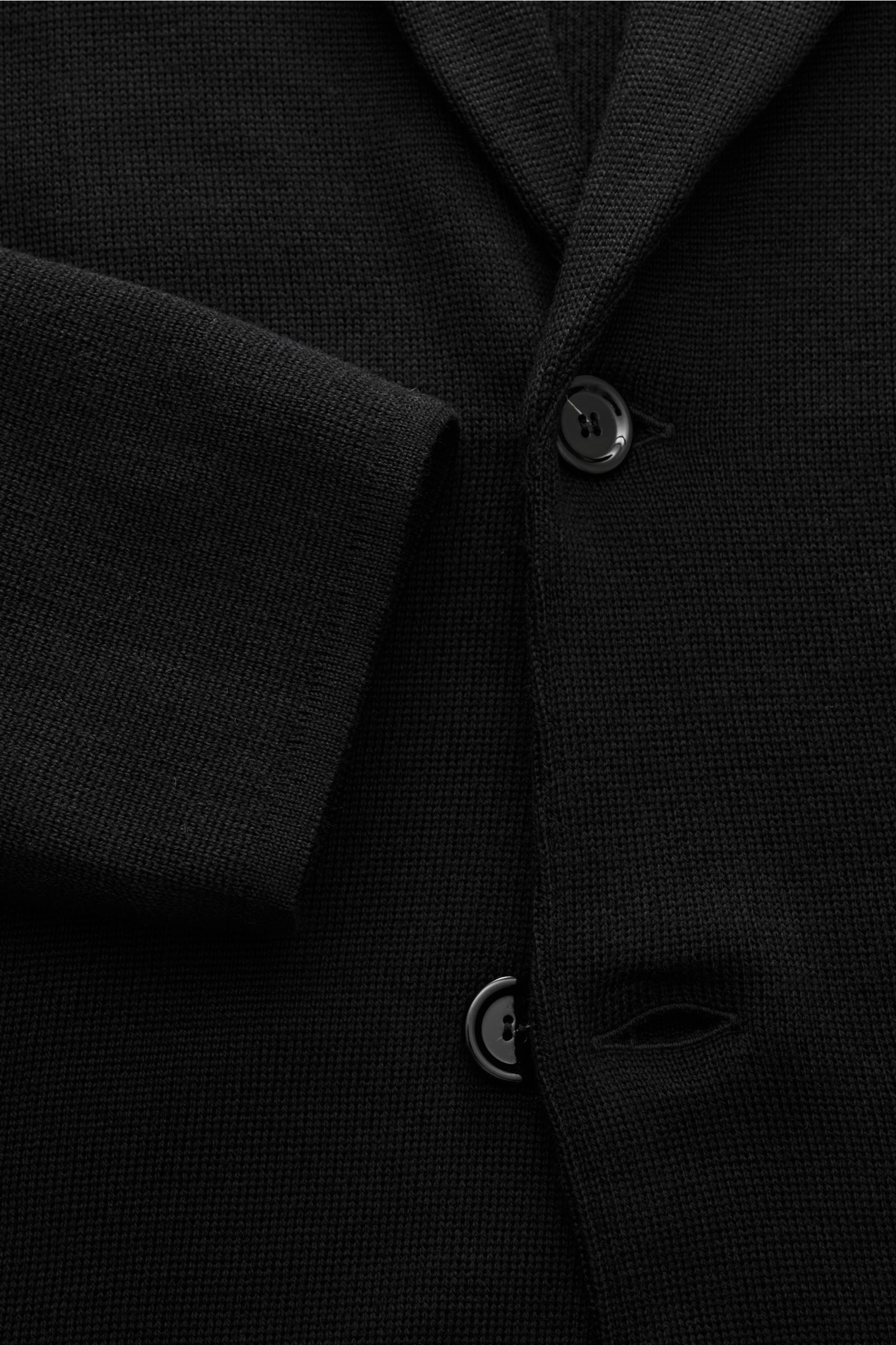 Lardini Knit blazer black shown in close-up front view, featuring pure wool knit, soft feel, fine knit texture, slim fit, two-button style, lapel with flower pin, side vents, patch hip pockets.