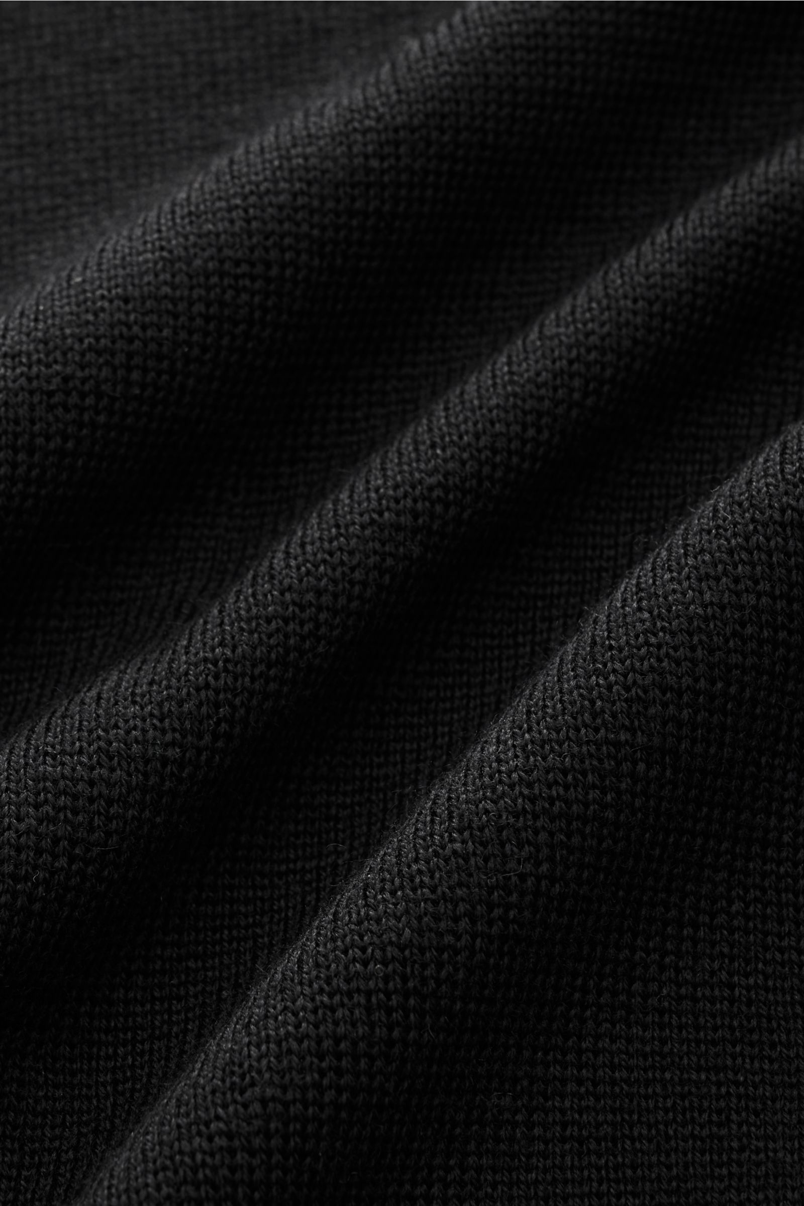 Close-up front view of the finely knit black wool fabric of the Lardini Knit blazer black, showcasing soft texture and quality.