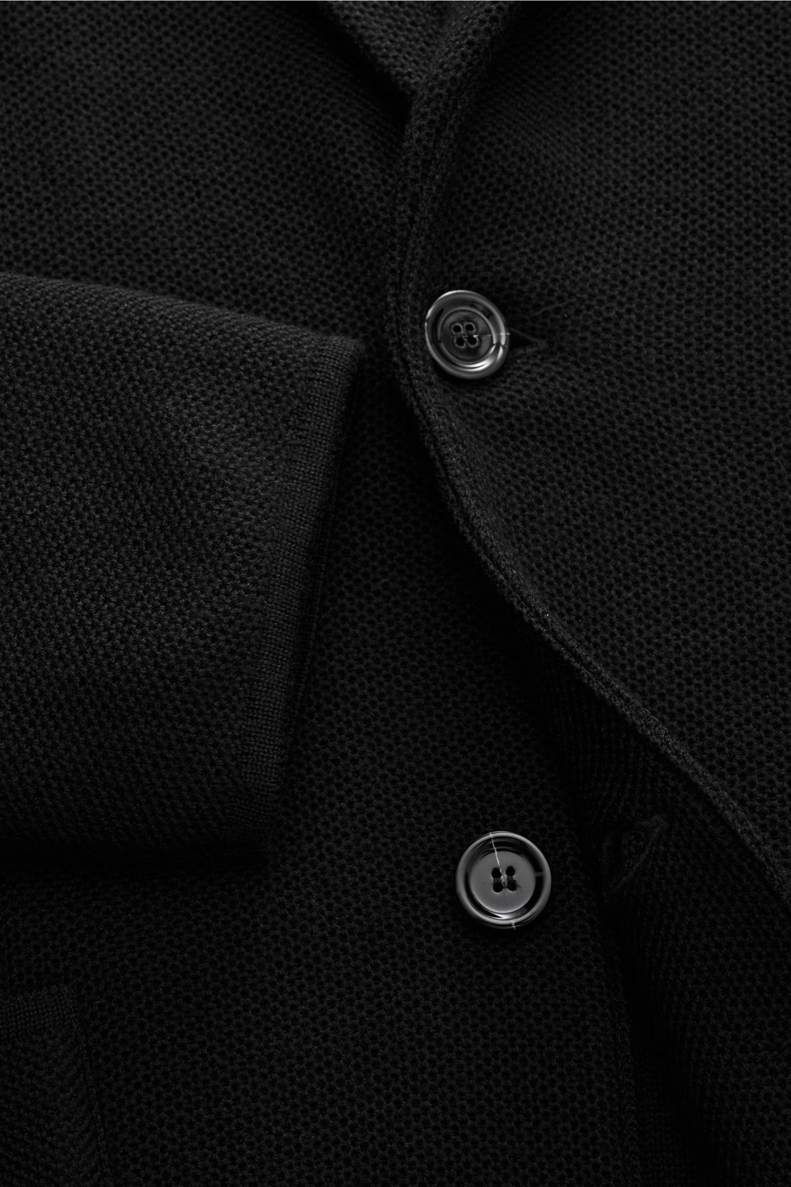 Close-up front view of the Lardini Knit blazer black showing finely textured wool, silk, and cashmere knit, soft feel, two buttons, and sleeve cuff.  

Stylish knitwear with character: This fitted knit blazer by LARDINI in a luxurious blend of wool, si