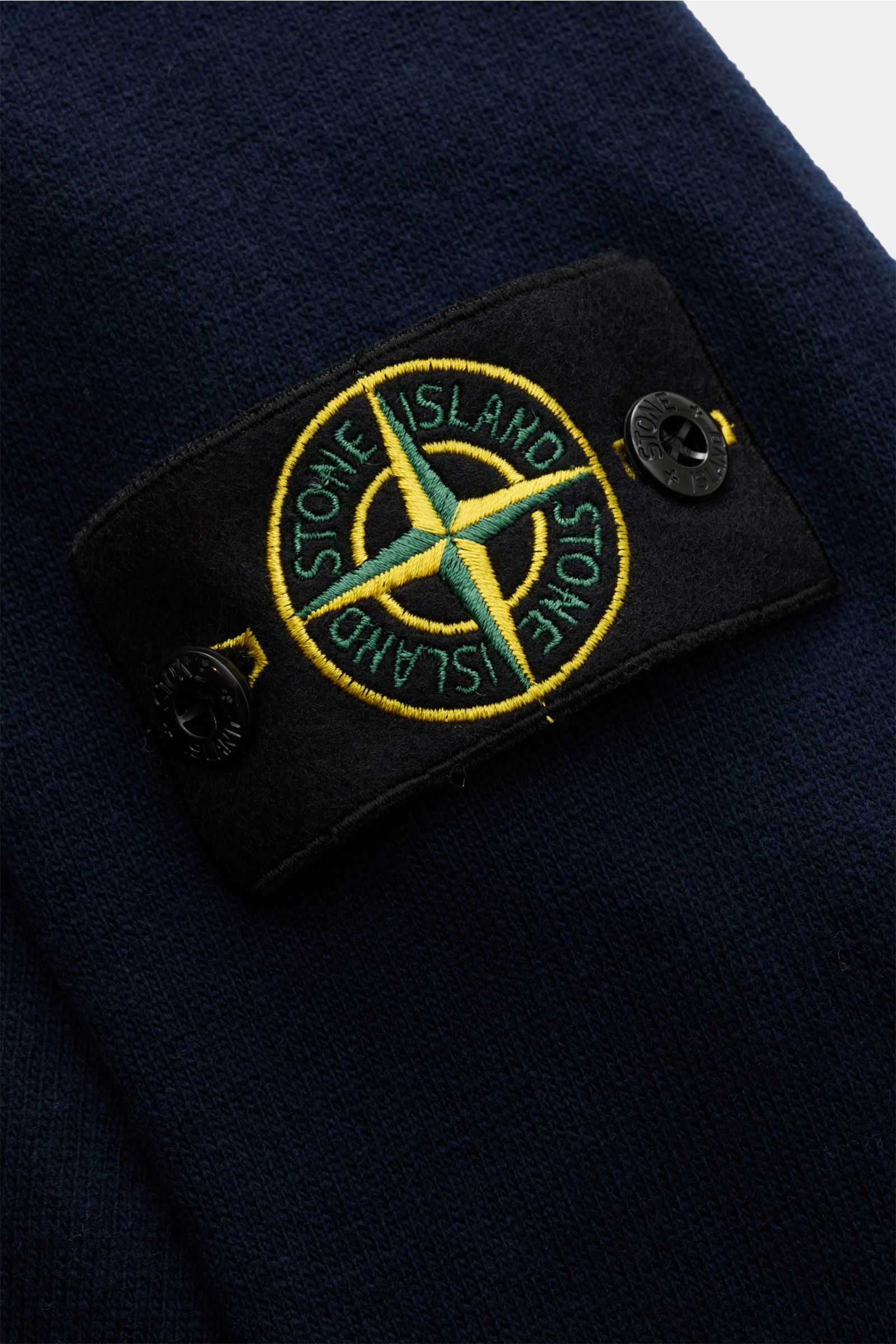 Stone Island Strickjacke navy mit Kompass-Badge am Ärmel, Detailaufnahme der zertifizierten Geelong-Schurwolle in feiner Jersey-Qualität.