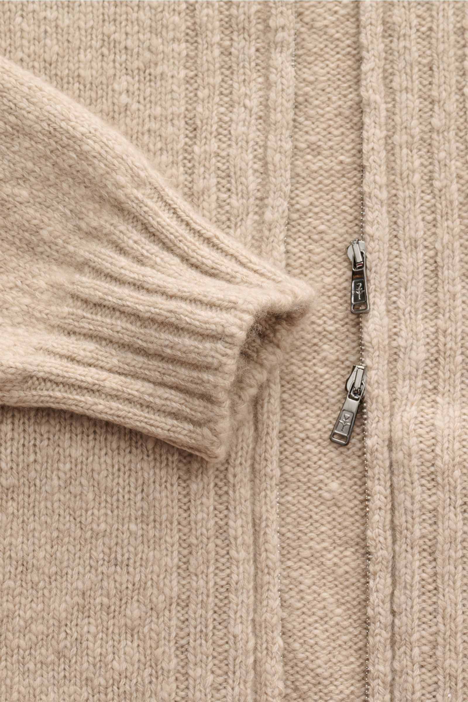 Close-up front view of Fioroni Cashmere Strickjacke sand meliert showing soft, mid-fine knit with light bouclé effect, slim fit, two-way zipper, slanted hip pockets, flexible ribbed cuffs, made of pure cashmere with very soft touch.
