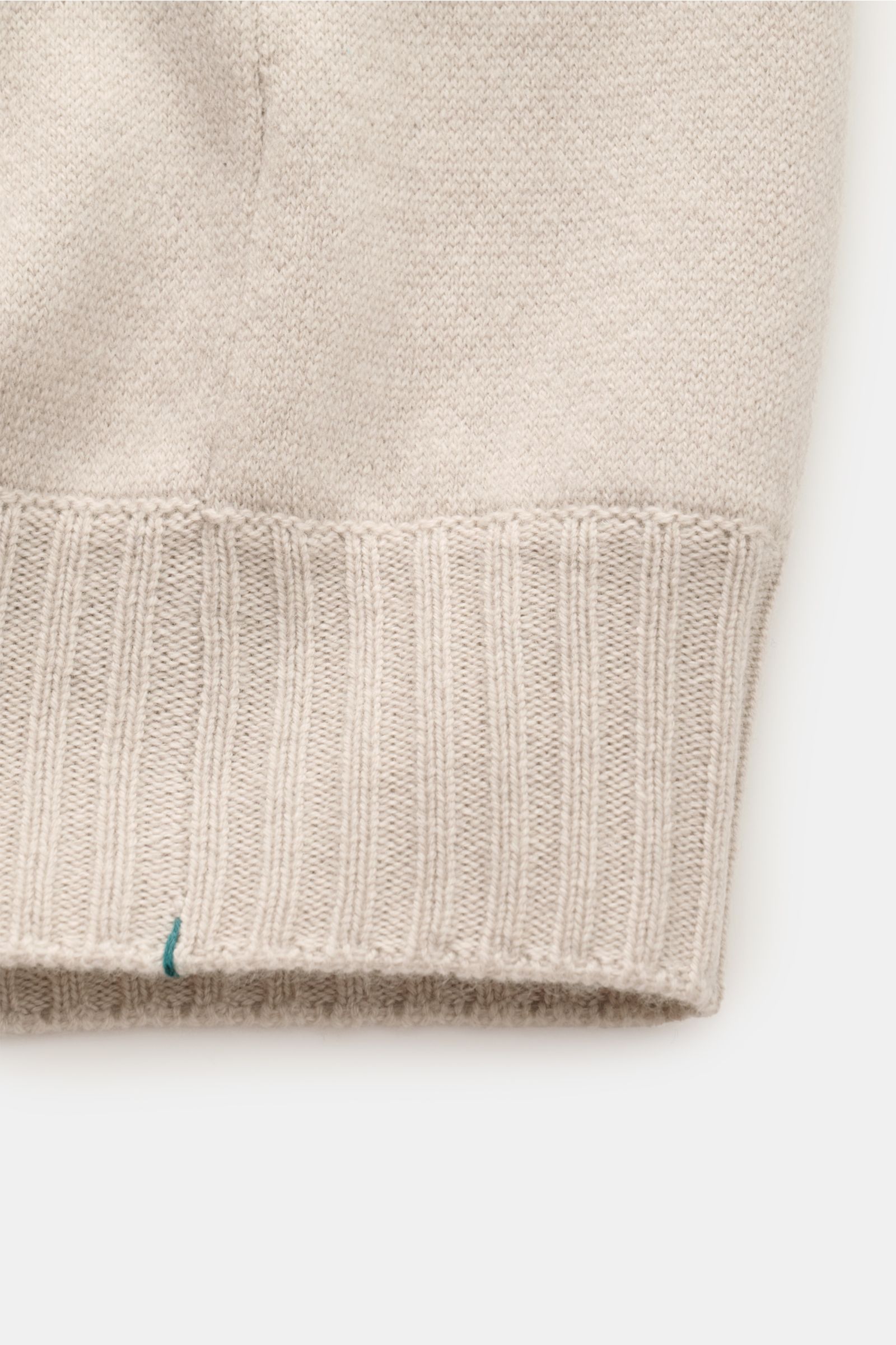 Close-up view of the ribbed cuff and knit texture of the Fioroni Cashmere Cardigan beige, showcasing fine knitting and soft cashmere material. Luxuriöser Cashmere für kalte Tage: Mit seinem besonders angenehmen, wärmenden Material bringt Sie der zeitlose 