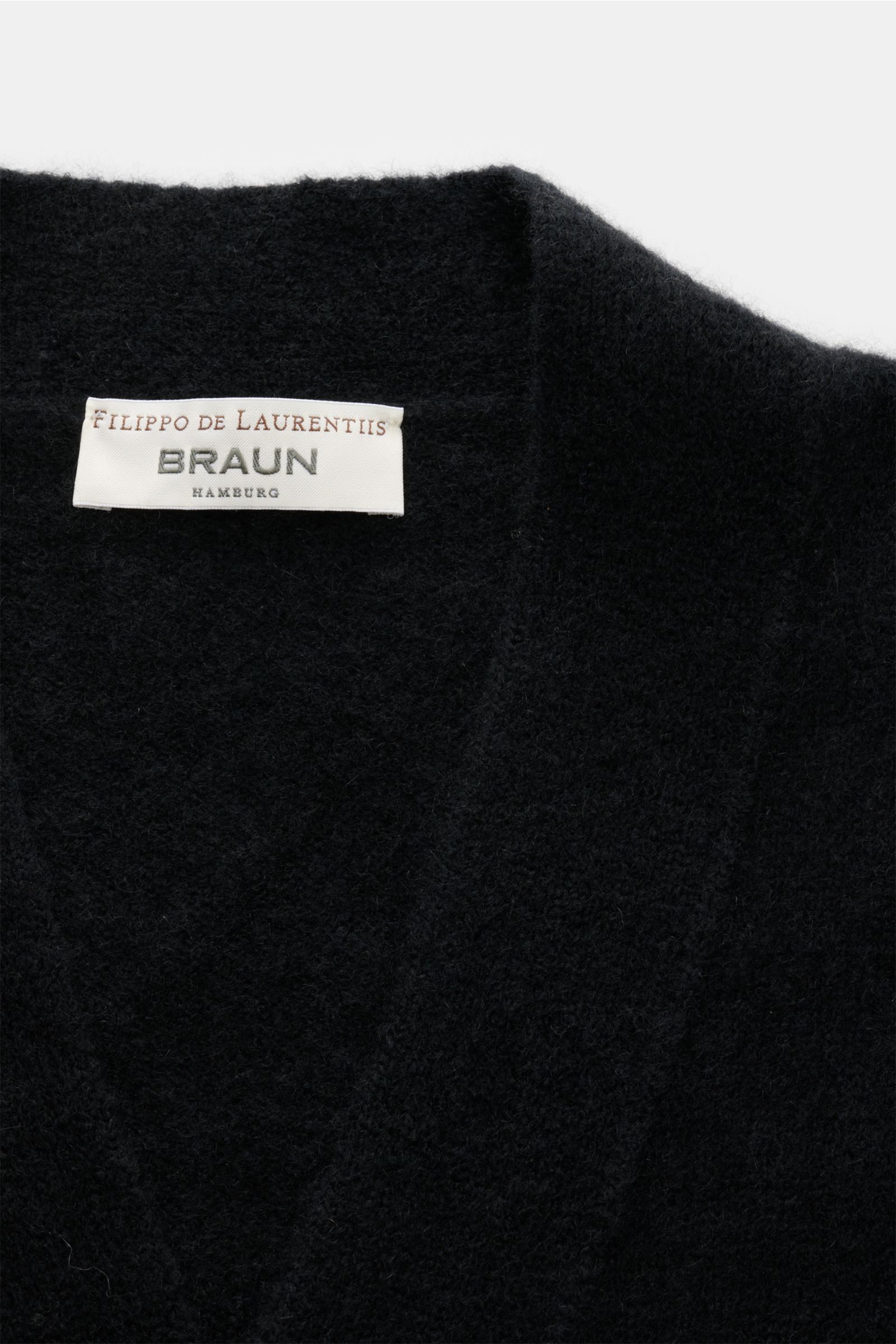 Close-up front view of the Filippo de Laurentiis Cardigan black, showing soft texture and label. A soft, luxurious blend of cashmere, silk and high-quality microfibre makes this cardigan by FILIPPO DE LAURENTIIS your new favourite for modern layering l