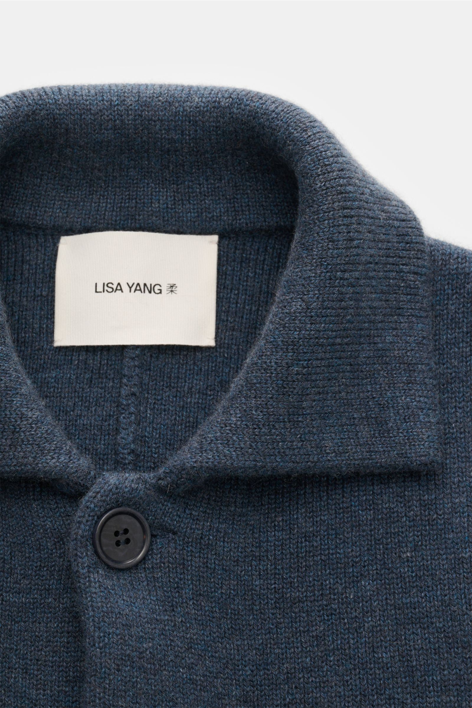 Close-up front view of the Lisa Yang Cashmere cardigan 'Louis' grey-blue, showing the knitted turn-down collar and the top button. Scandinavian lines by LISA YANG: The cardigan 'Louis' is made of heavy fabric in fine cashmere and is an essential piece for