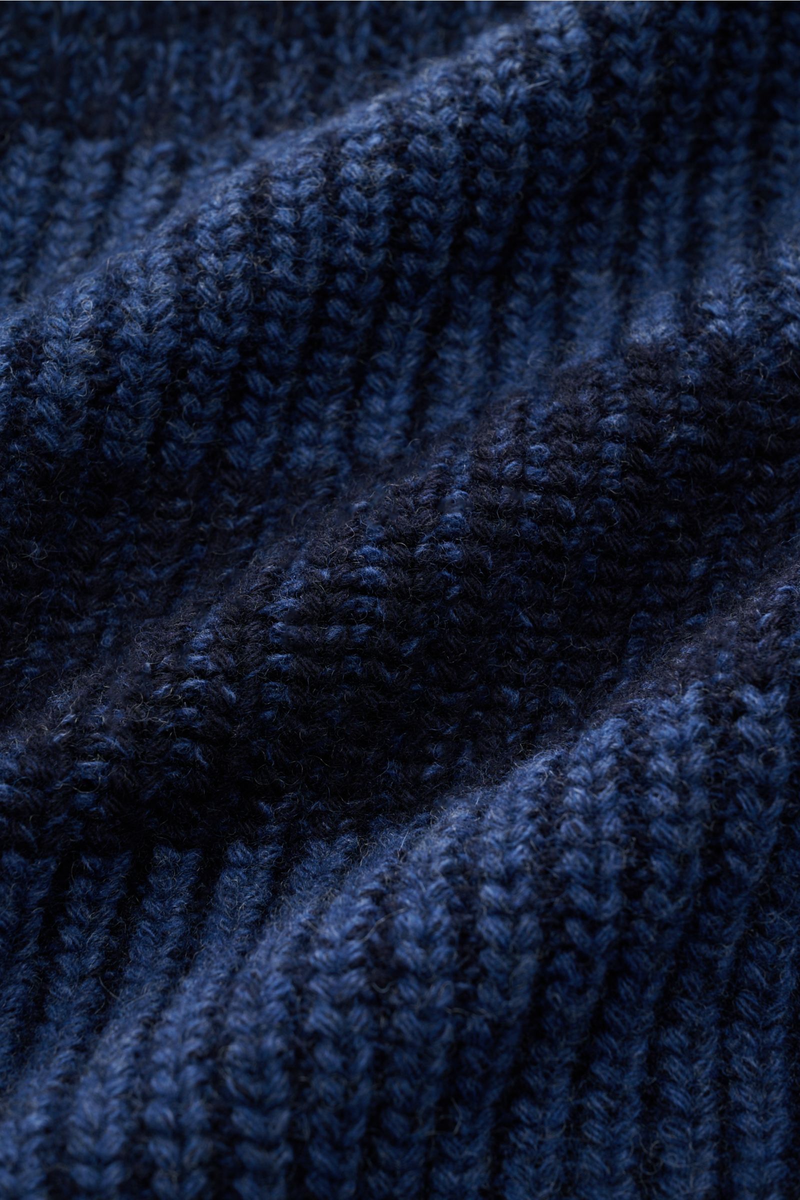 Nahaufnahme der voluminösen, weichen Strickstruktur der Barbour Strickjacke 'Knit Bomber' blau/navy gestreift aus reiner Wolle.
