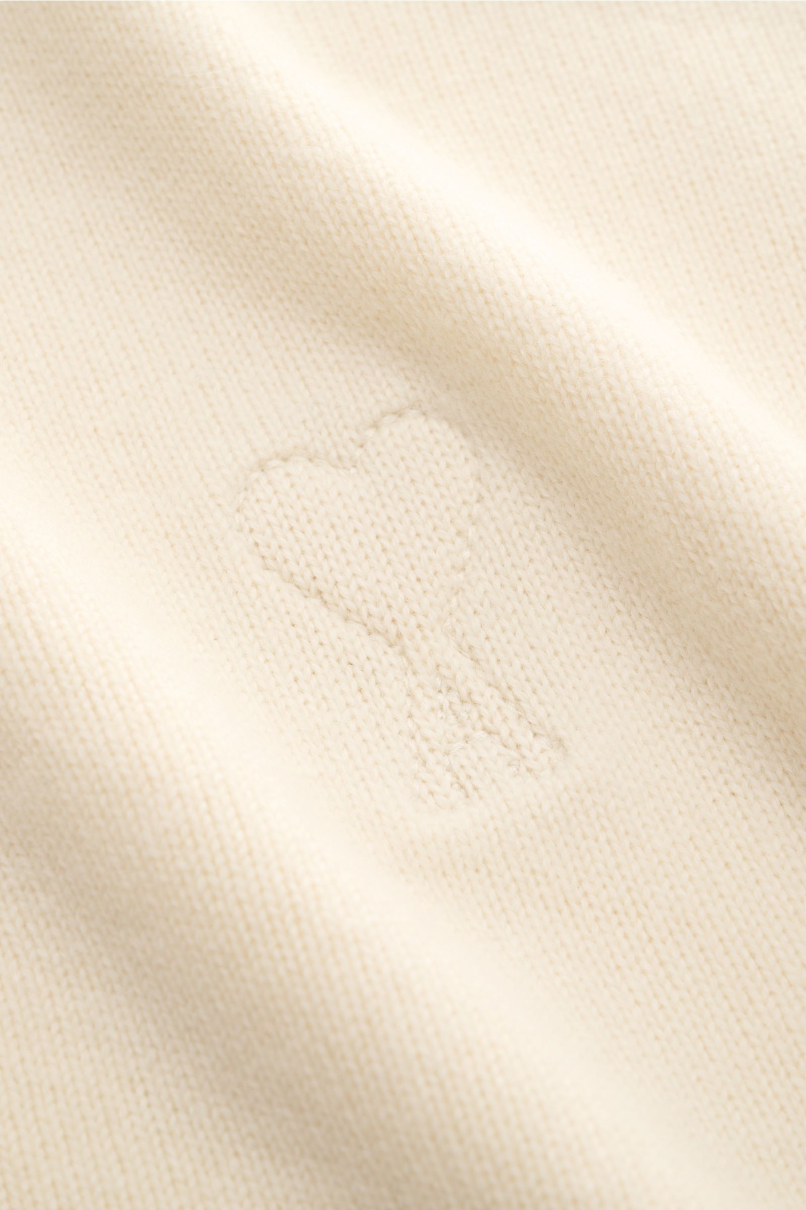 Close-up front view of Ami Paris Cardigan cream showing wool and cashmere knit with quilted 'Ami' heart logo detail.