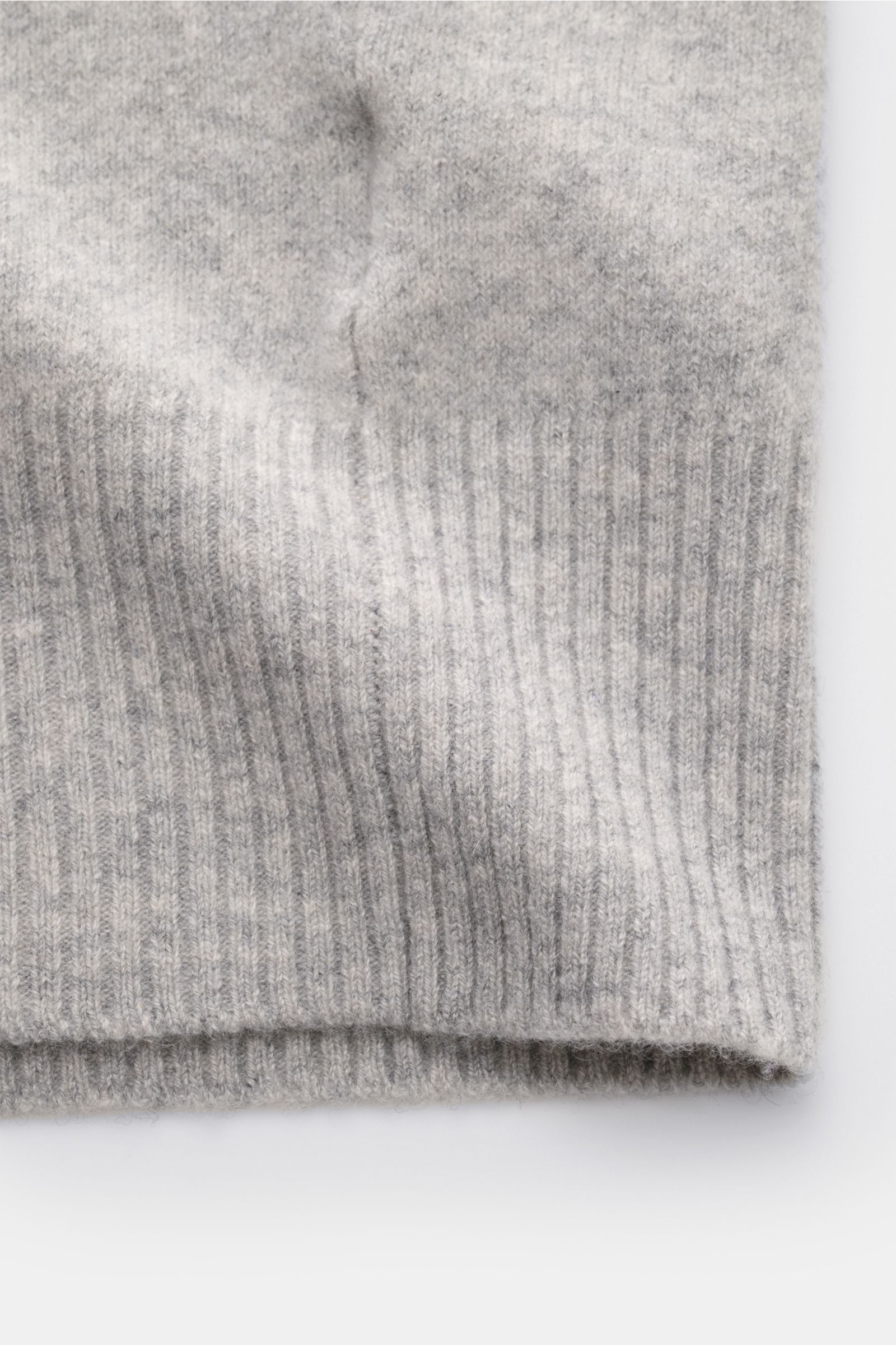 Nahaufnahme des FTC Cashmere Cardigan grau meliert, Fokus auf elastische, mittelfeine Strickqualität und komfortable Rippbündchen aus Fair-Trade-Cashmere.
