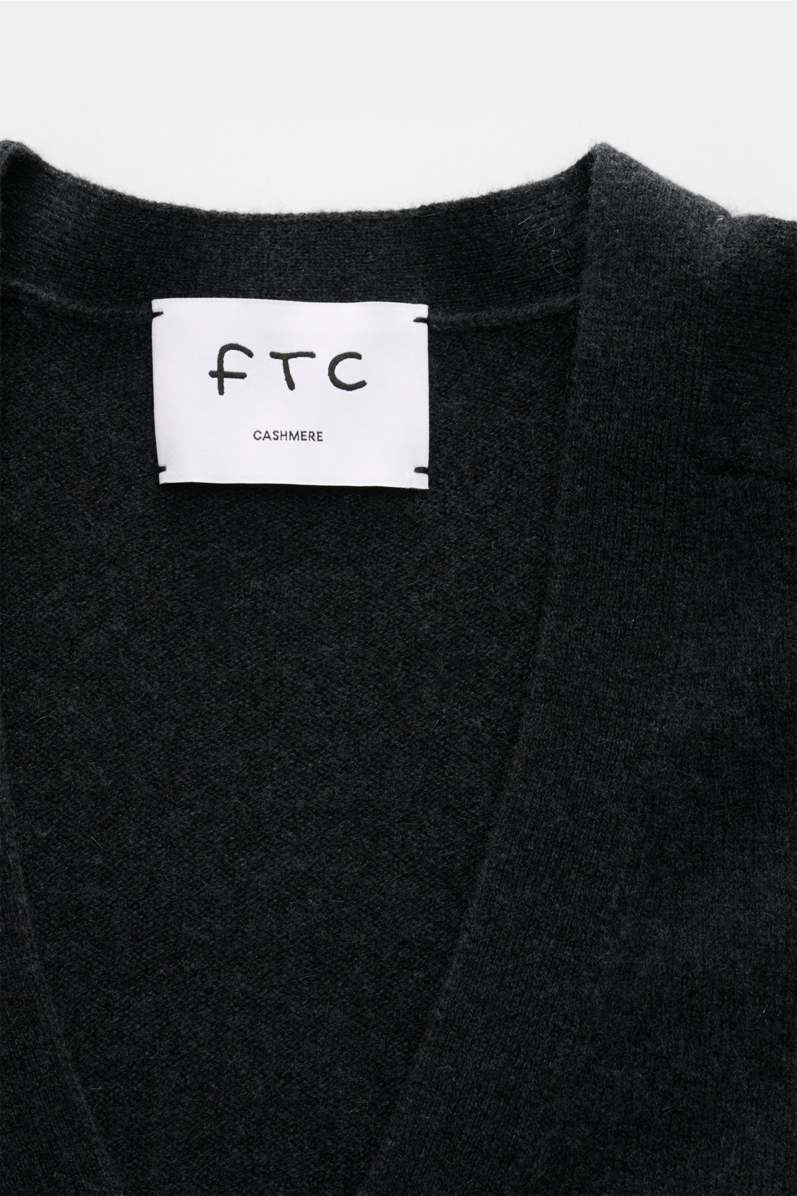 Alt tag (125 characters max): Close-up front view of FTC Cashmere cardigan anthracite showing soft, medium-fine knit fabric and V-neck collar.

Description:  
This luxurious cardigan by eco-friendly knitwear label FTC is a soft knitwear essential in pu