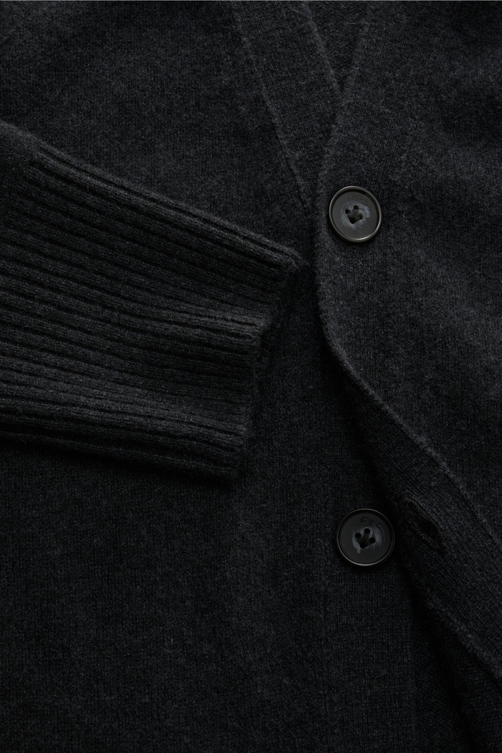 Alt tag (125 characters): Close-up top-down view of the FTC Cashmere cardigan anthracite showing ribbed sleeve cuff and four-button placket details.

This luxurious cardigan by eco-friendly knitwear label FTC is a soft knitwear essential in pure, fair 