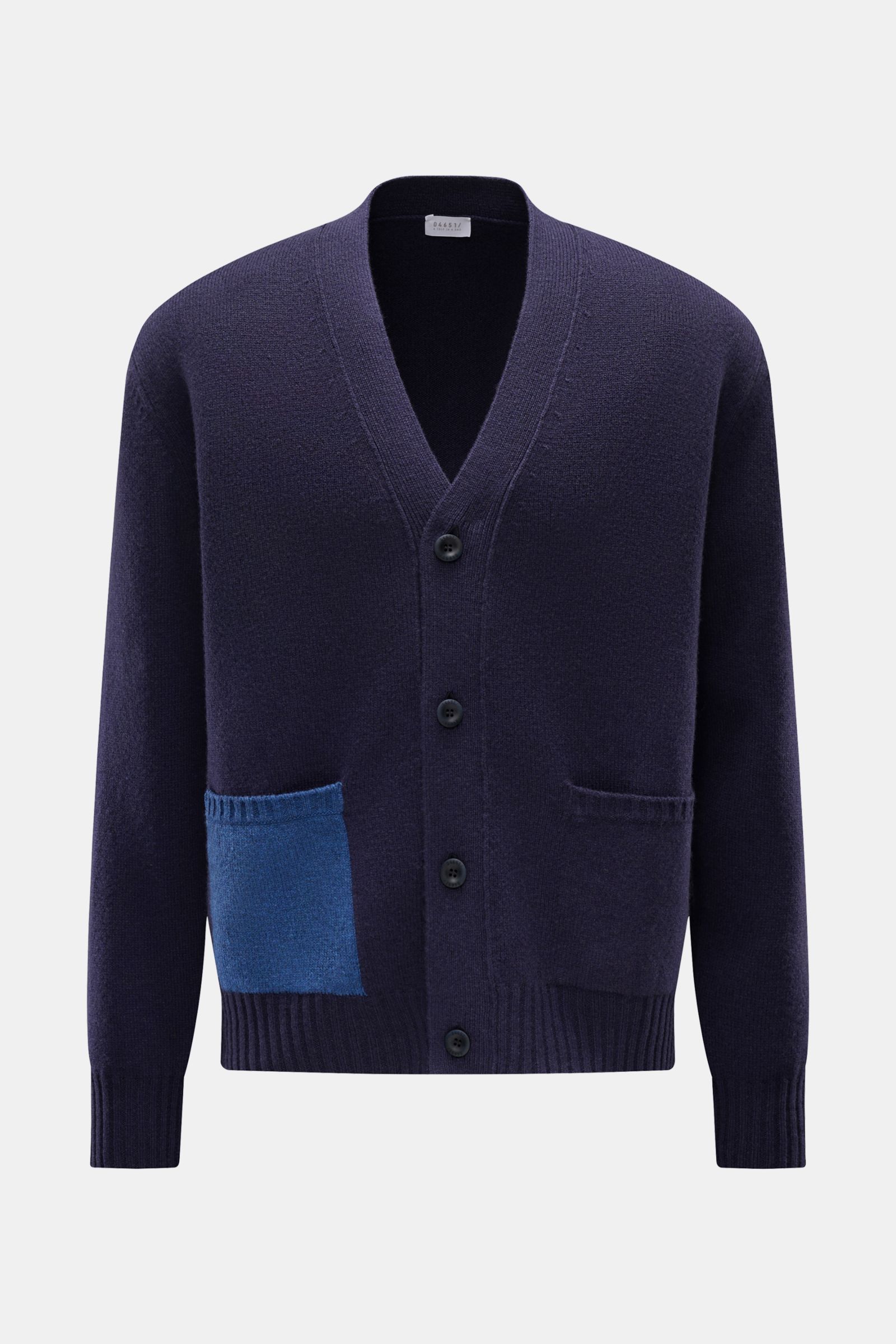 Front view of 04651/ A trip in a bag Cardigan navy in fine wool and cashmere blend, featuring soft feel, fine knit, oversized fit, four-button placket, contrasting blue hip pocket, and ribbed bands. Subtle luxury with comfortable design.