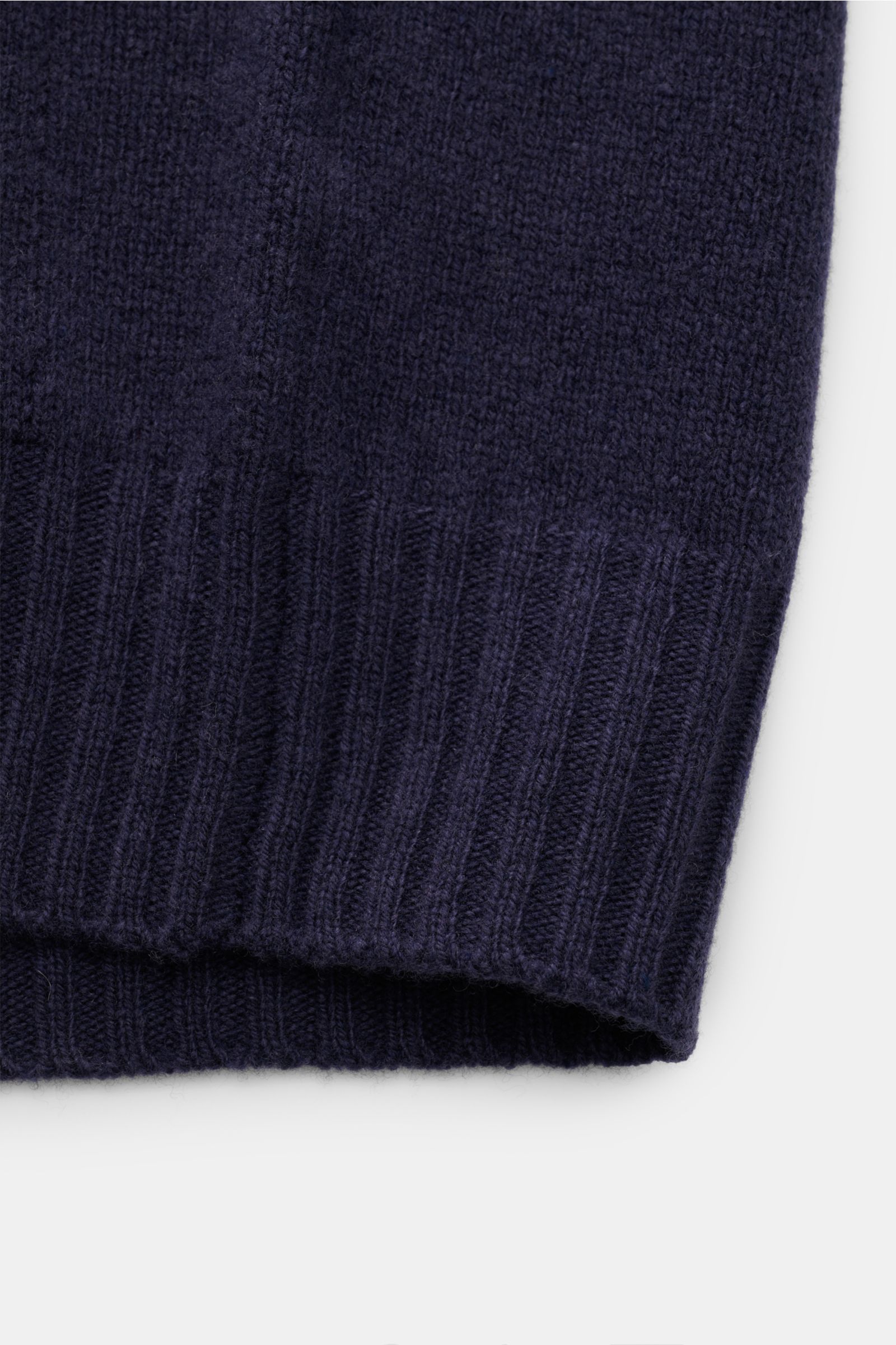 Close-up of the ribbed cuff of the 04651/ A trip in a bag Cardigan navy, showing fine knit wool and cashmere fabric texture.

Description: 
Subtle luxury: Fine material in wool and cashmere and the contrasting pocket make this cardigan by 04651/ A TRIP