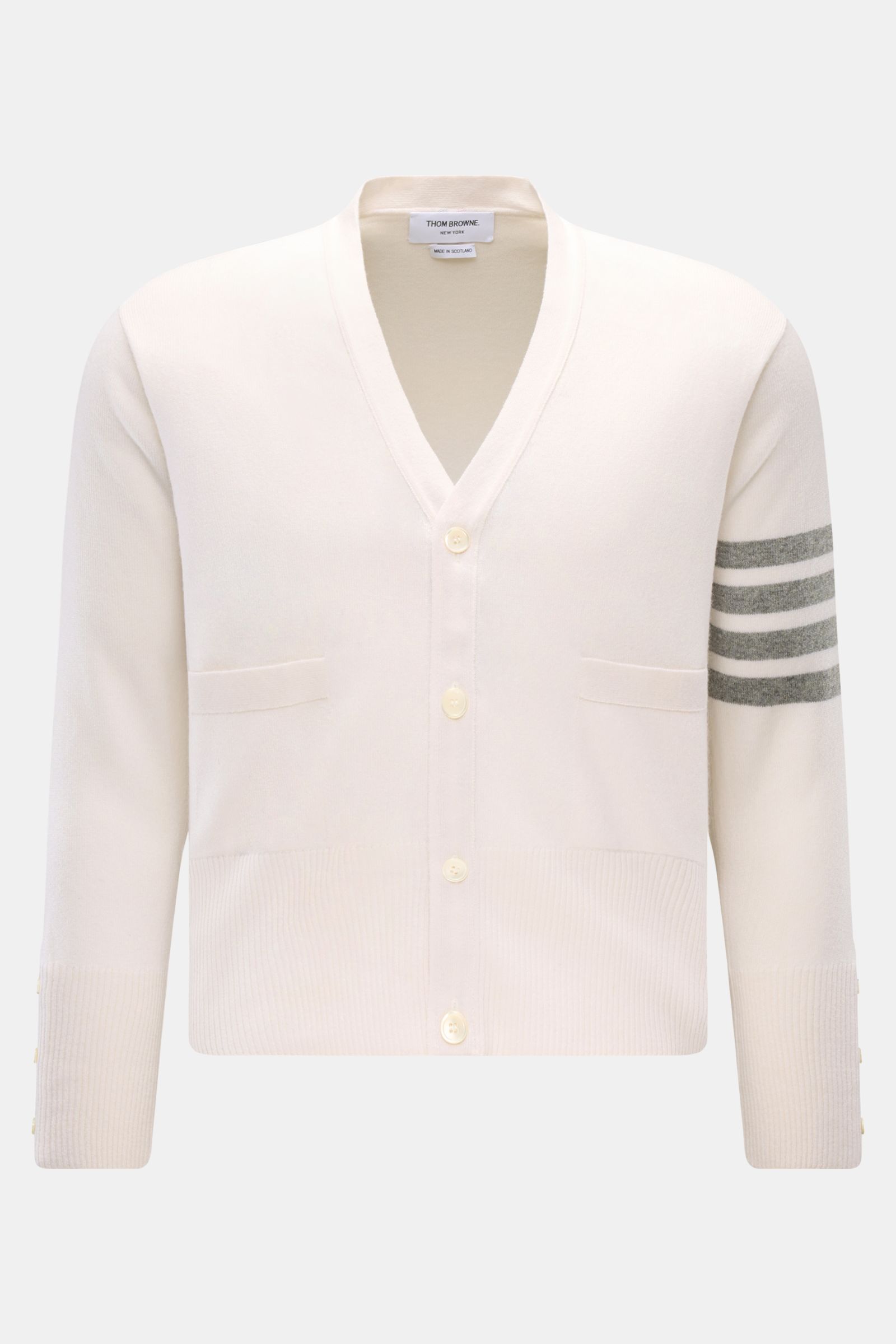 Thom Browne Cashmere Cardigan offwhite shown from the front, featuring pure cashmere, soft feel, fine knit, regular fit, button placket, front pockets, wide rib cuffs, and buttoned side slits.