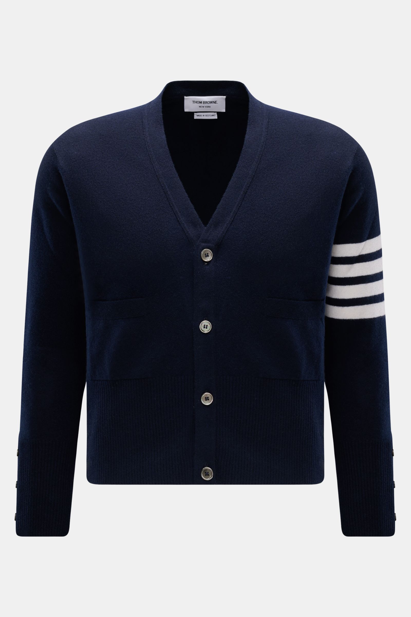 Front view of Thom Browne Cashmere Cardigan navy in pure cashmere with soft touch, fine knit, regular fit, button placket, front pockets, wide rib cuffs, and side buttoned slits.