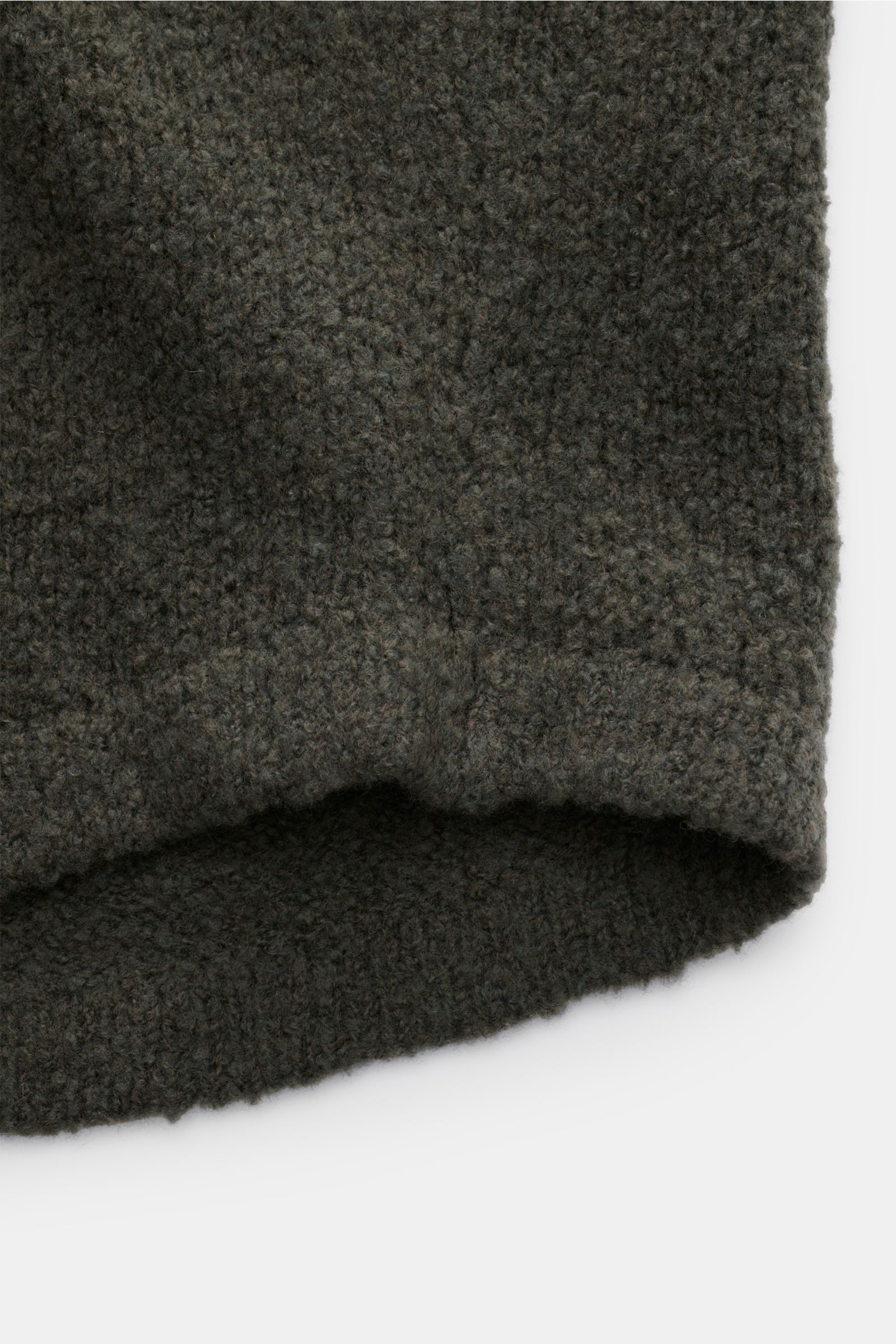 Close-up front bottom view of 04651/ A trip in a bag Cardigan 'Chunky Overshirt' olive showing its voluminous knit and soft virgin wool blend texture.