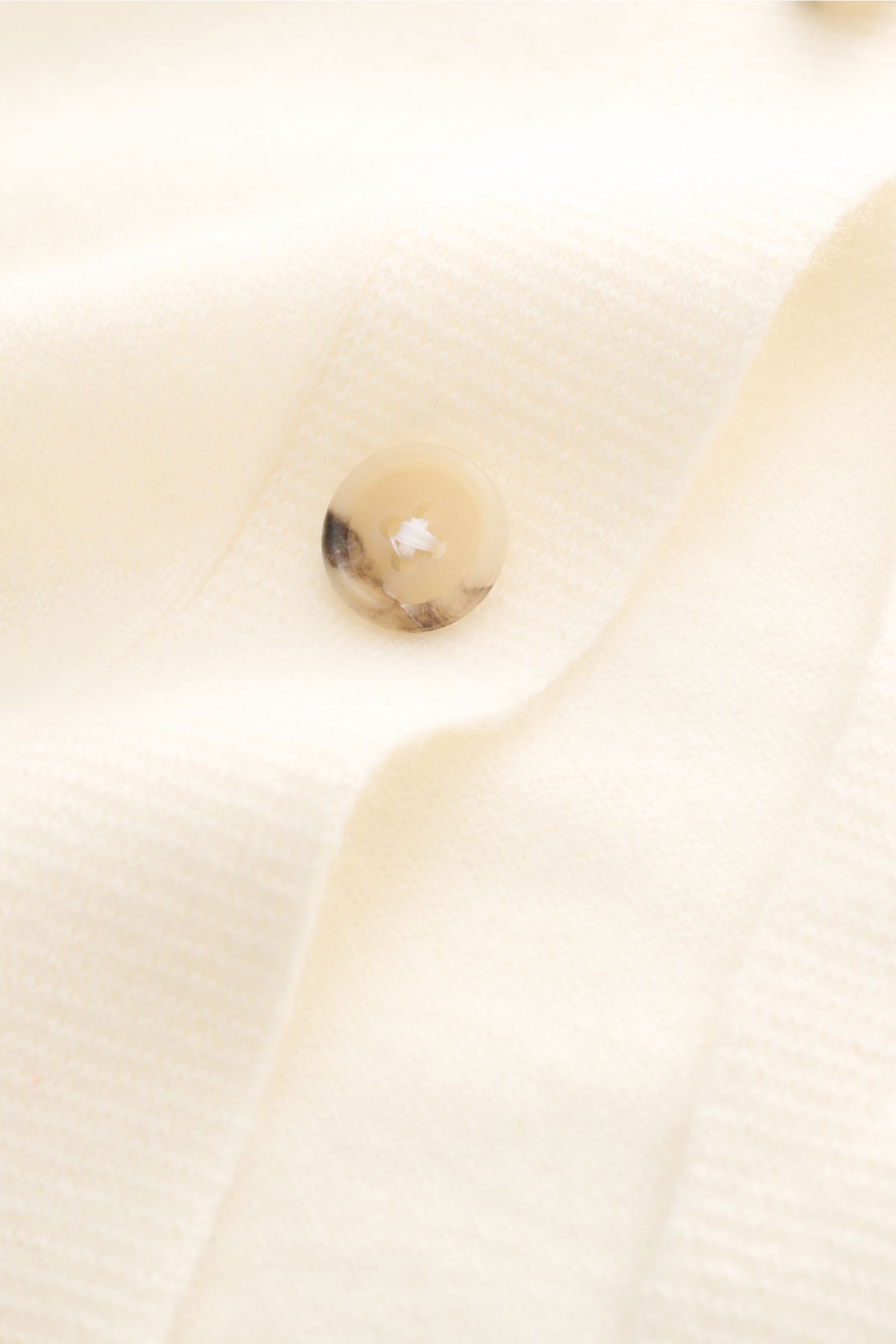 Close-up front view of the Fioroni Cashmere cardigan cream showing smooth button placket, fine knit, and soft texture. Exquisite craftsmanship from Italy: This cardigan by FIORONI is precisely made from fine material in precious baby cashmere.  
- Pure ca