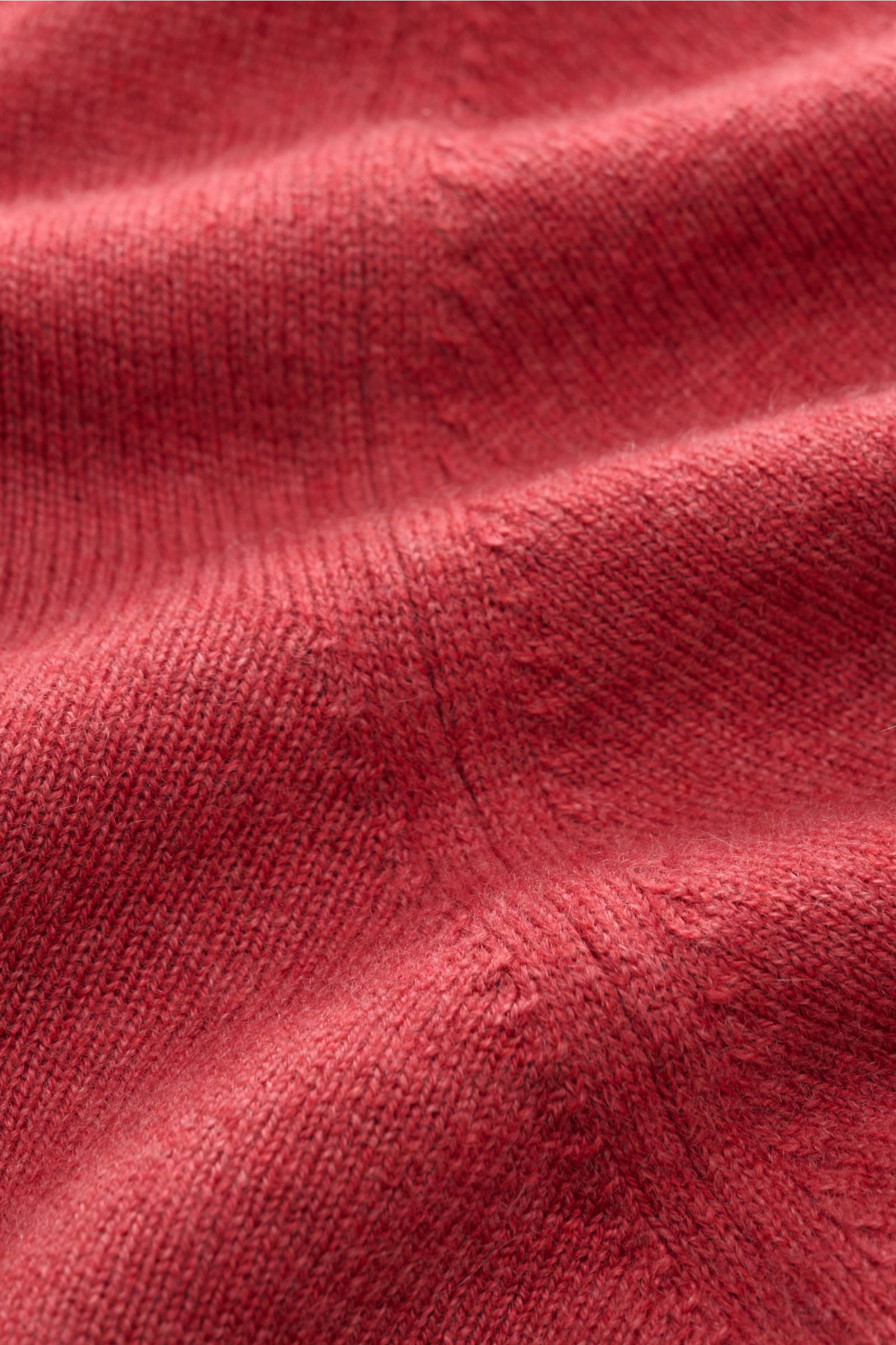 Close-up view of the soft, fine knit texture of the Brunello Cucinelli Cashmere Strickjacke hellrot in light red, showcasing its smooth cashmere fabric and delicate details.

Luxus für die Freizeitgarderobe bietet BRUNELLO CUCINELLI mit dieser Strickja