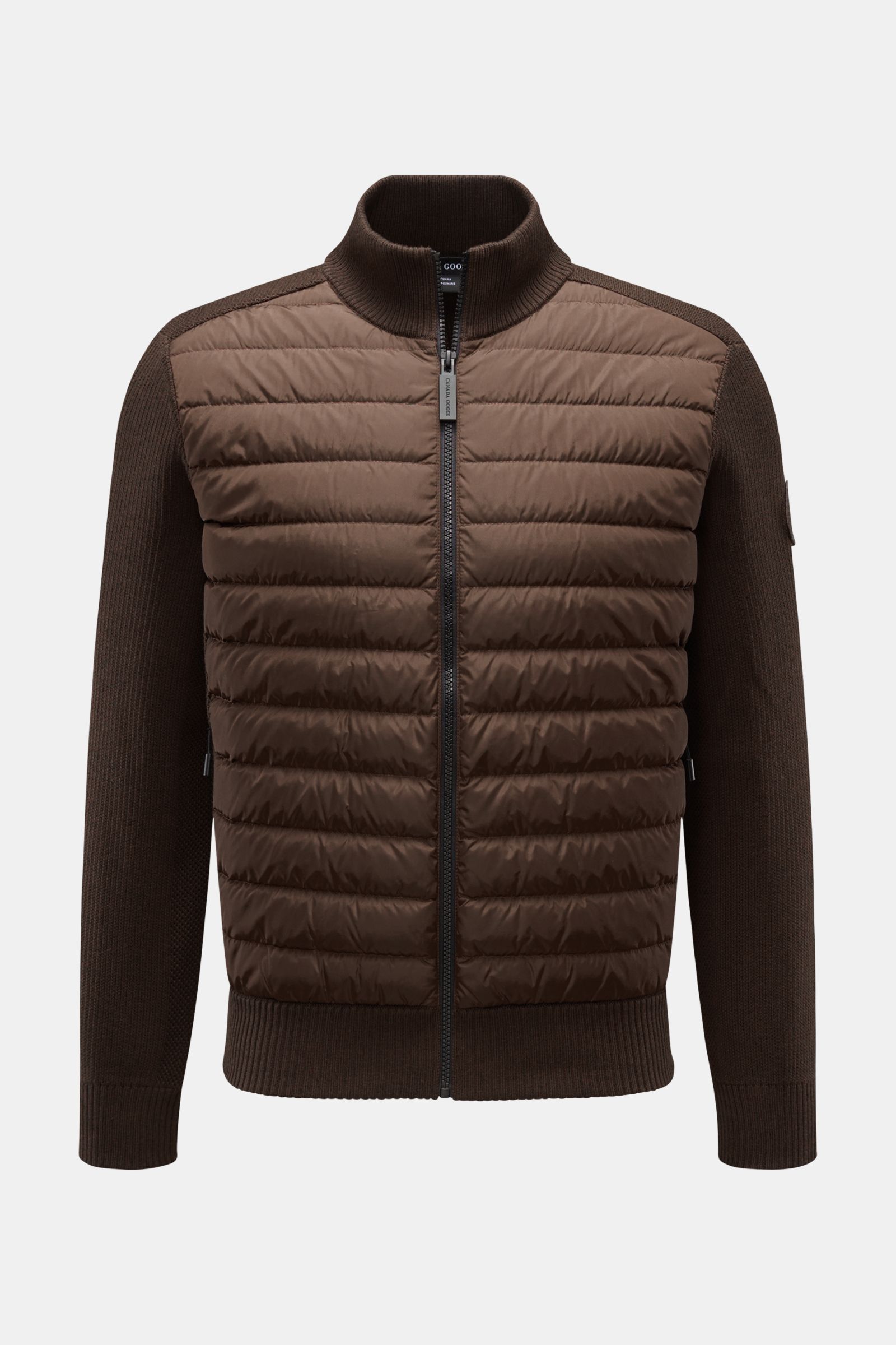 Front view of Canada Goose Cardigan 'Hybridge Knit' dark brown with pure wool knit sleeves and down-lined quilted front.

Description: Make a smooth transition into the new season with the cardigan 'Hybridge Knit' from the outdoor label CANADA GOOSE, w