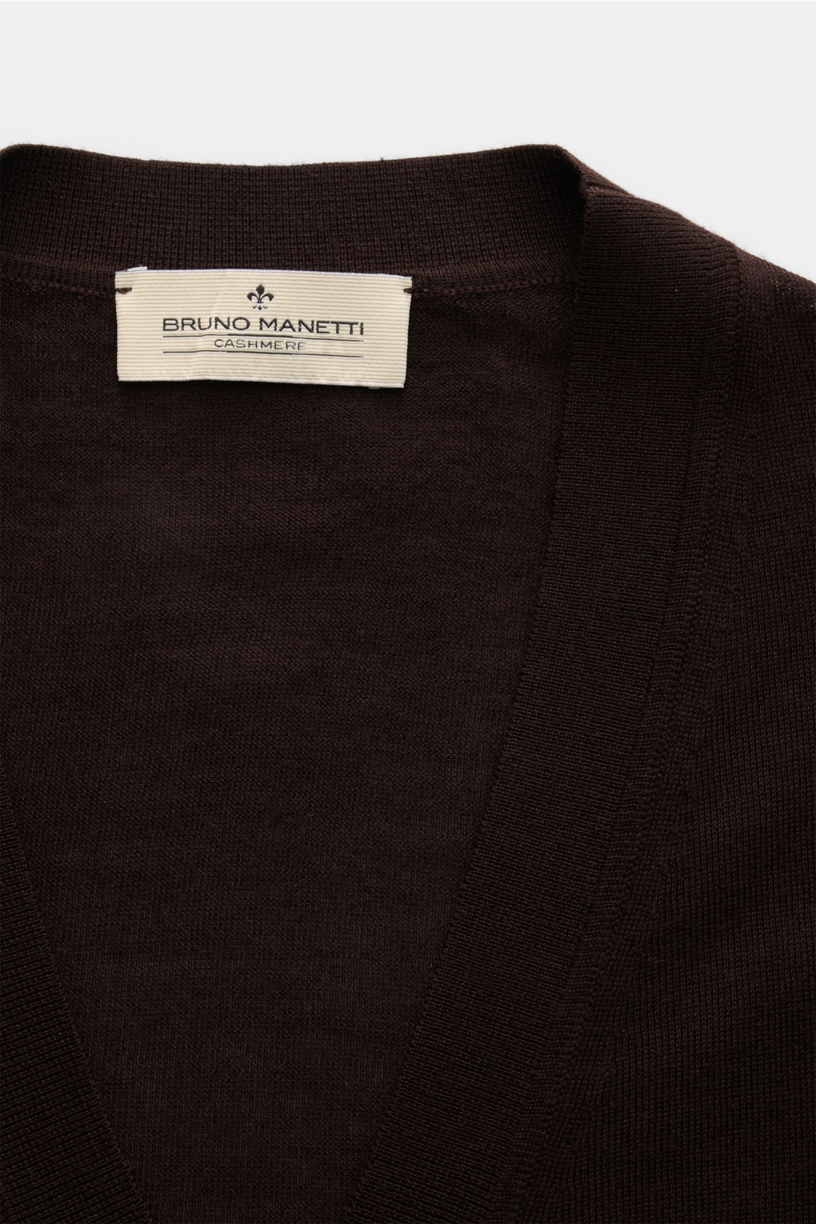 Close-up front view of the dark brown Bruno Manetti Cashmere silk cardigan showing its fine knit, V-neck, and label. Luxury you can feel on your skin: this fine knit cardigan by BRUNO MANETTI has an exceptionally soft feel and timeless elegance. The luxur