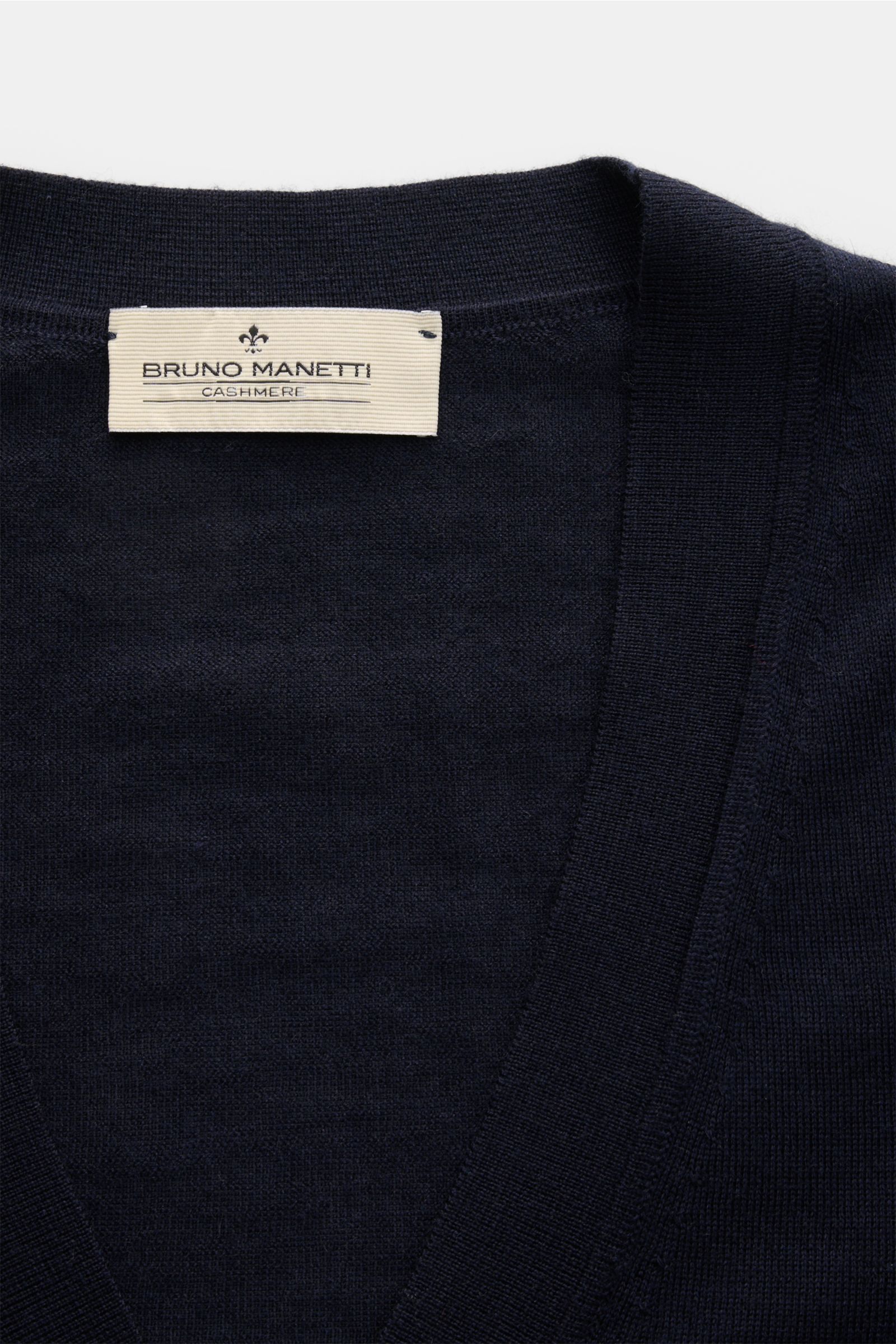 Close-up front view of Bruno Manetti Cashmere-silk cardigan navy showcasing the V-neck, fine knit, and label. Luxury you can feel on your skin: This fine knit cardigan by BRUNO MANETTI has an exceptionally soft feel and timeless elegance. The luxurious bl