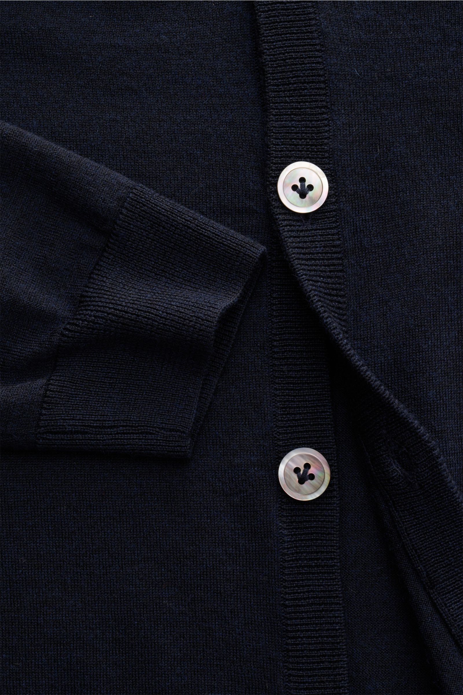 Close-up front view of FTC Cardigan navy showing fine knit fabric, ribbed cuff, and mother-of-pearl buttons on a slim-fit V-neck.

This luxurious cardigan by eco-friendly knitwear label FTC is a soft knitwear essential made of fair trade cashmere in a 