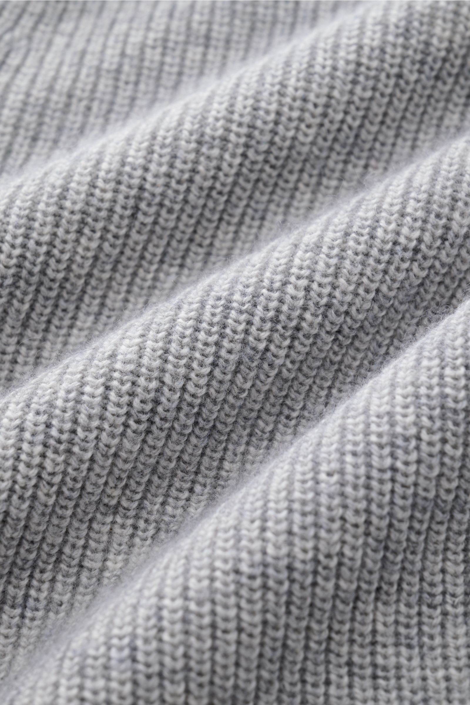 Close-up, detailed view of the soft, medium-fine knit fabric of the FTC Cardigan grey, highlighting its ribbed texture.

This luxurious cardigan from sustainable knitwear label FTC is a classic knitted essential made from cotton and fair trade cashmere