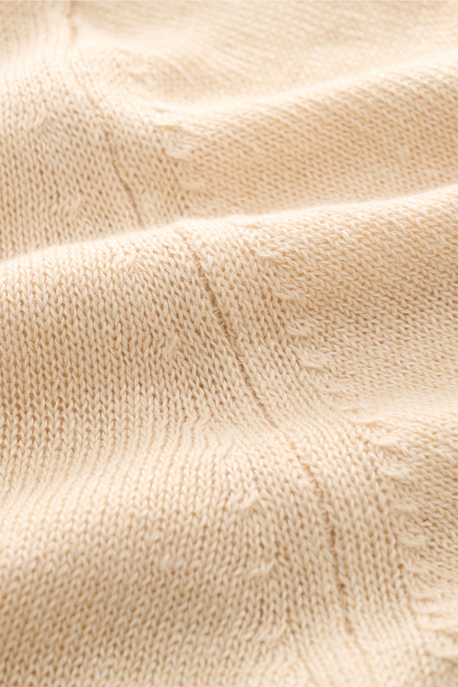 Close-up front view of the Filippo de Laurentiis Cardigan sand showing its fine, lightweight knit texture, soft blend of linen and cotton, regular fit, five-button placket, patch hip pockets, and comfortable ribbed cuffs, styled as an elegant layering pie