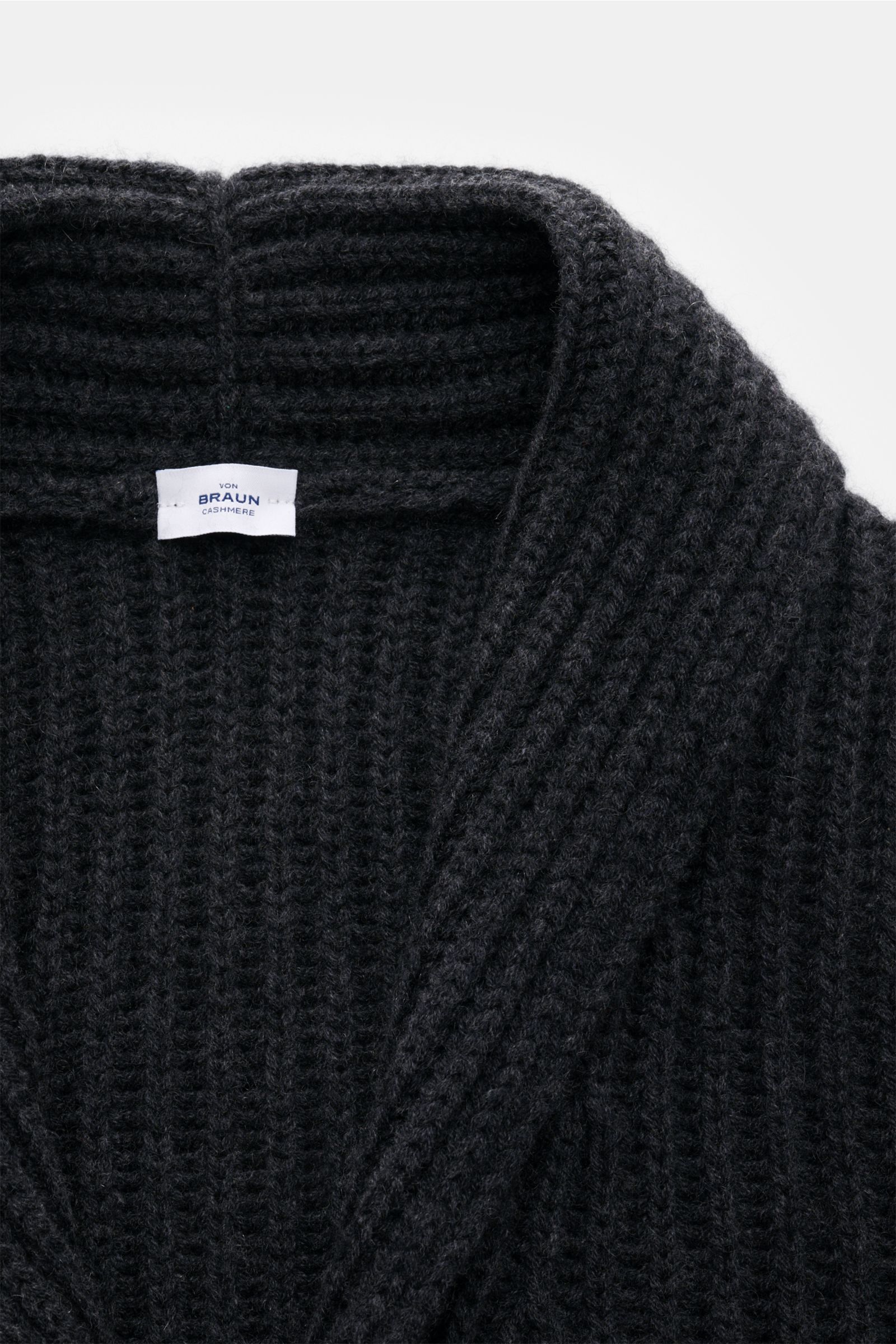 Close-up front view of von Braun Cashmere cardigan anthracite mottled in chunky brioche stitch with shawl collar and four-button placket.

Description: How about a less chunky knit? This cardigan in brioche stitch from the VON BRAUN Cashmere collection