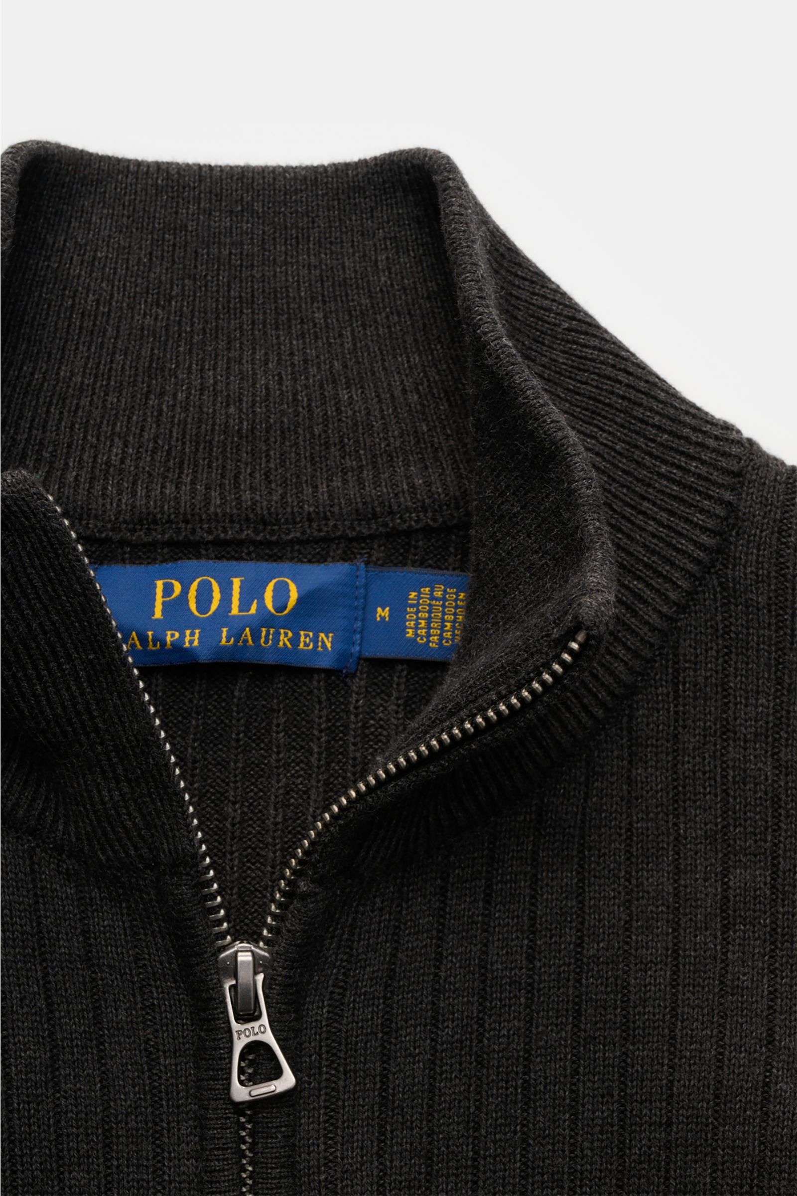 Close-up front view of Polo Ralph Lauren Cardigan anthracite showing ribbed texture, high collar, and branded zipper pull. 

This ribbed cardigan in pure cotton by POLO RALPH LAUREN adds an extra layer of comfort from spring to winter. With a concealed